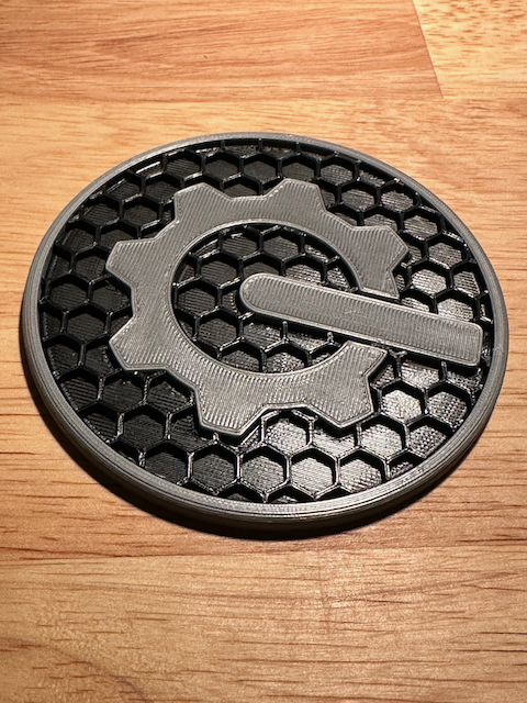 Coaster with gear logo