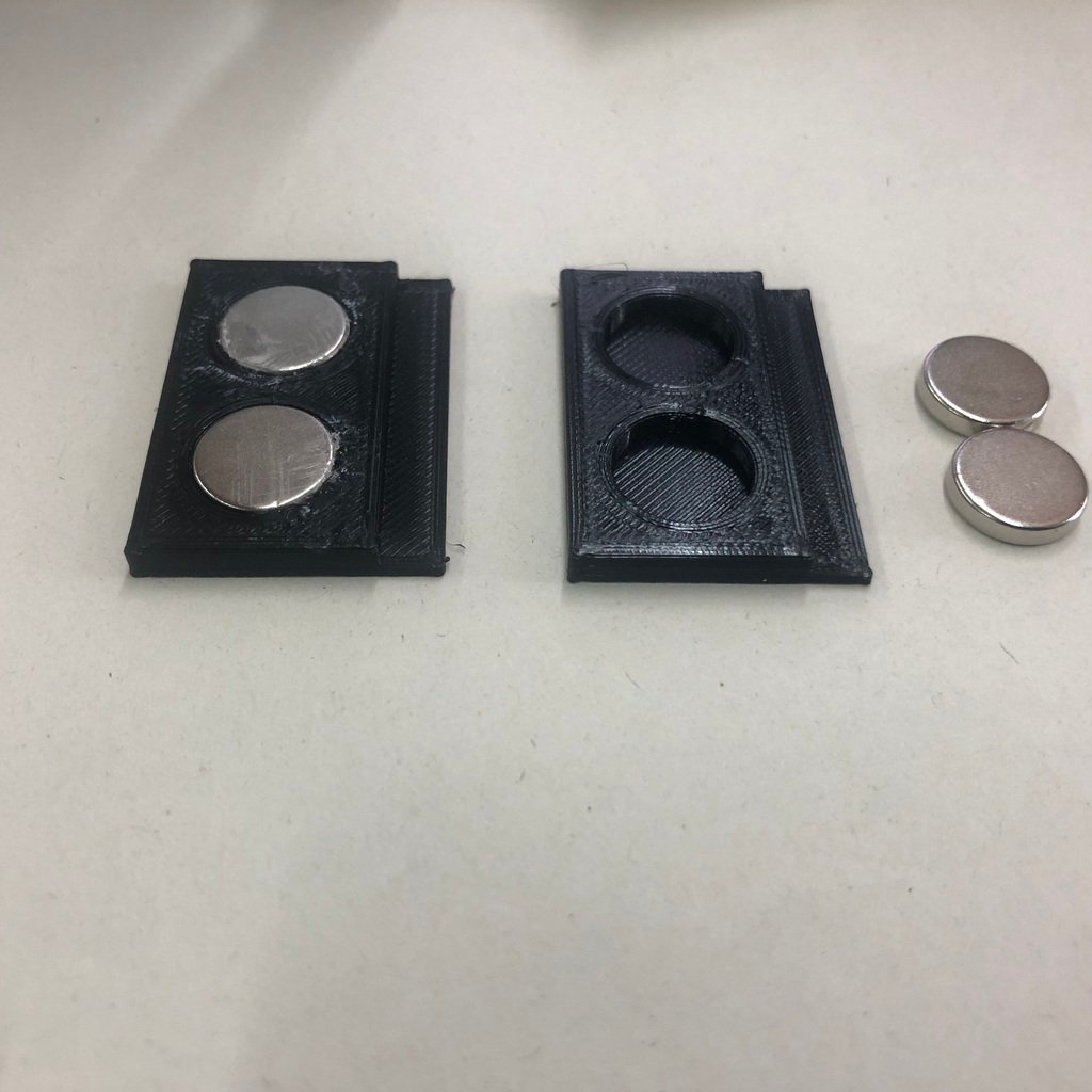 Magnetic holddown for honeycomb bed on laser engraver