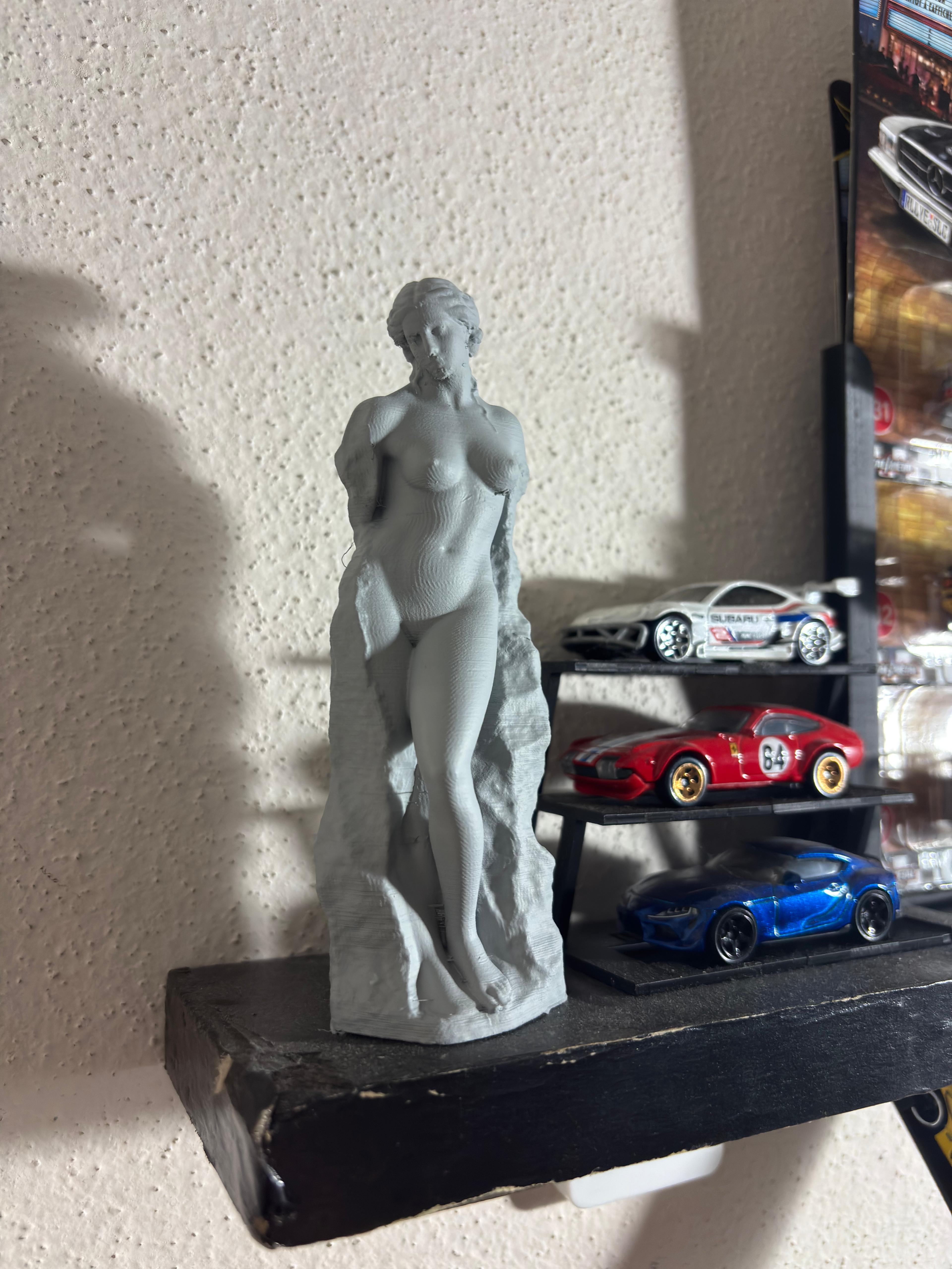 female body carved out of stone statue