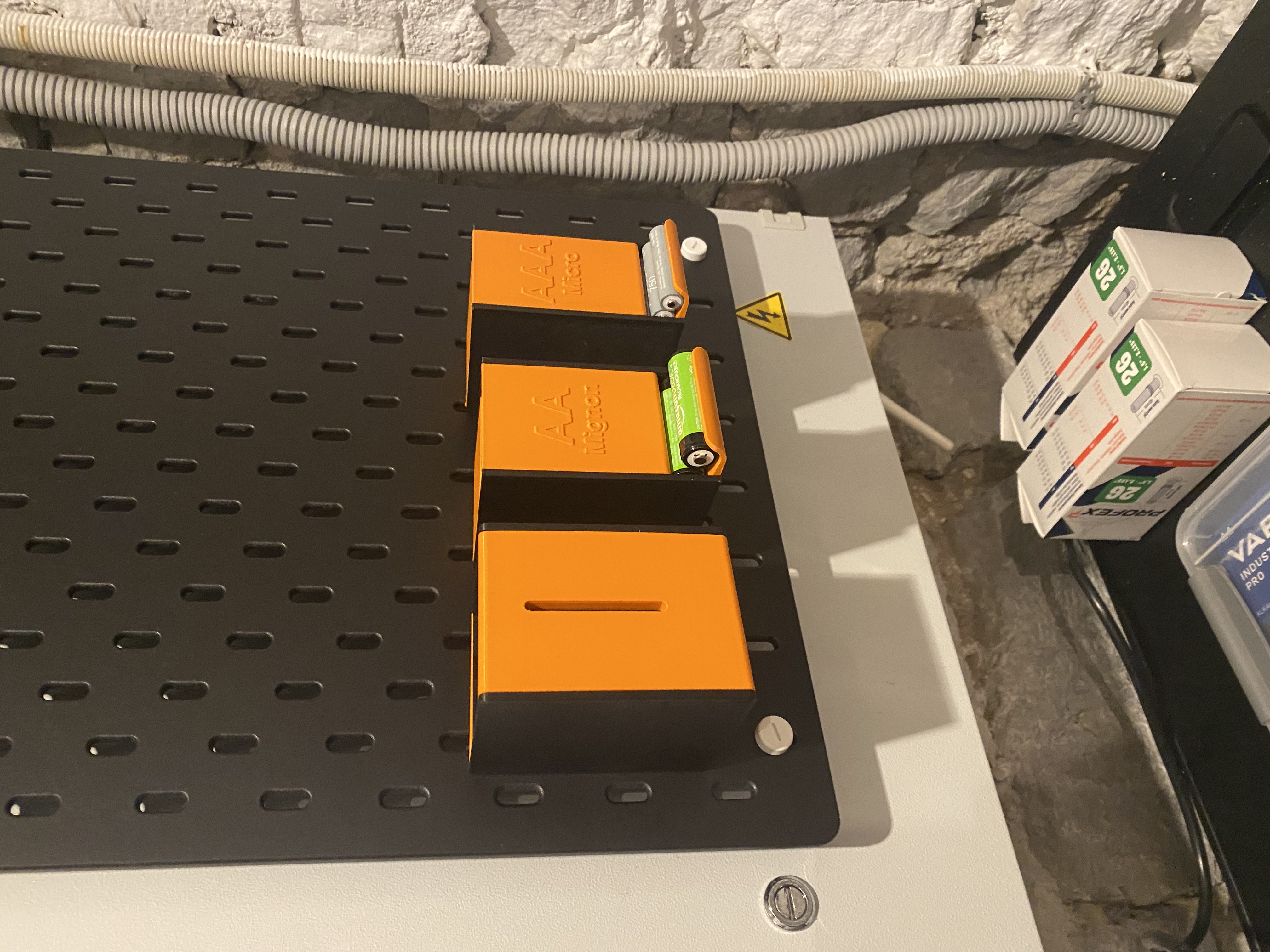 Drained/empty battery container for Skadis pegboard