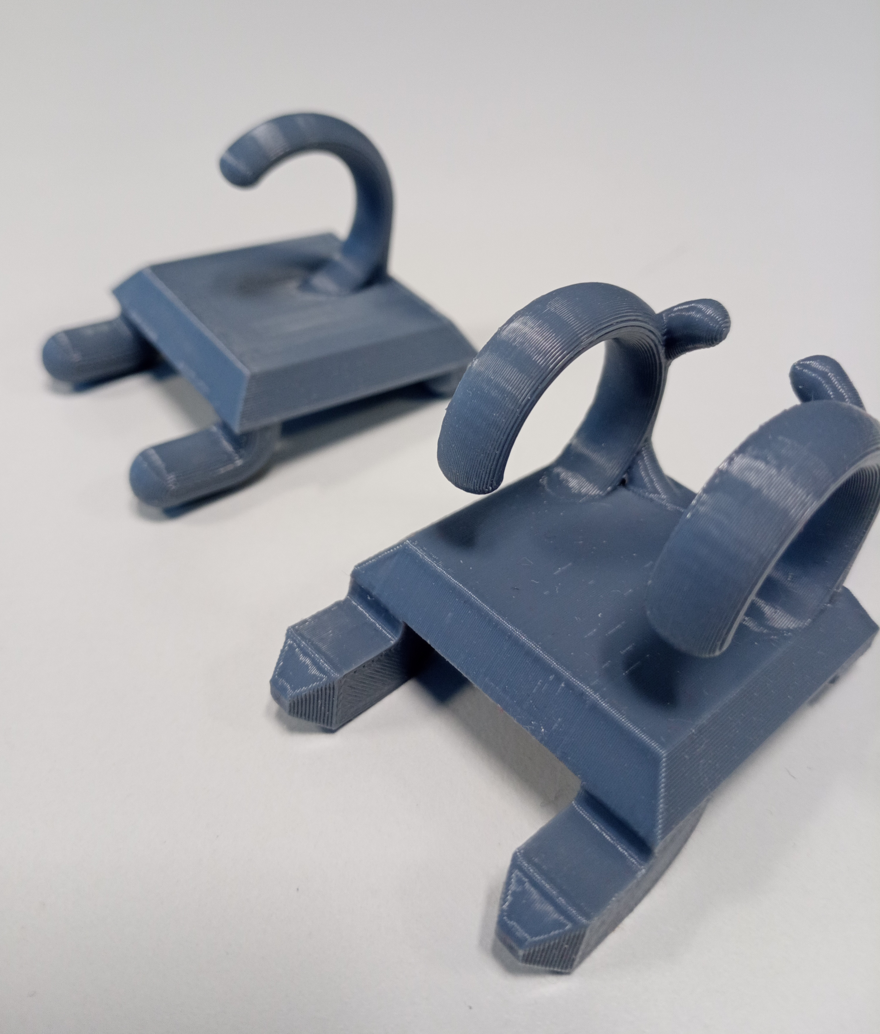Pluggable coat and cable holder for industrial tables