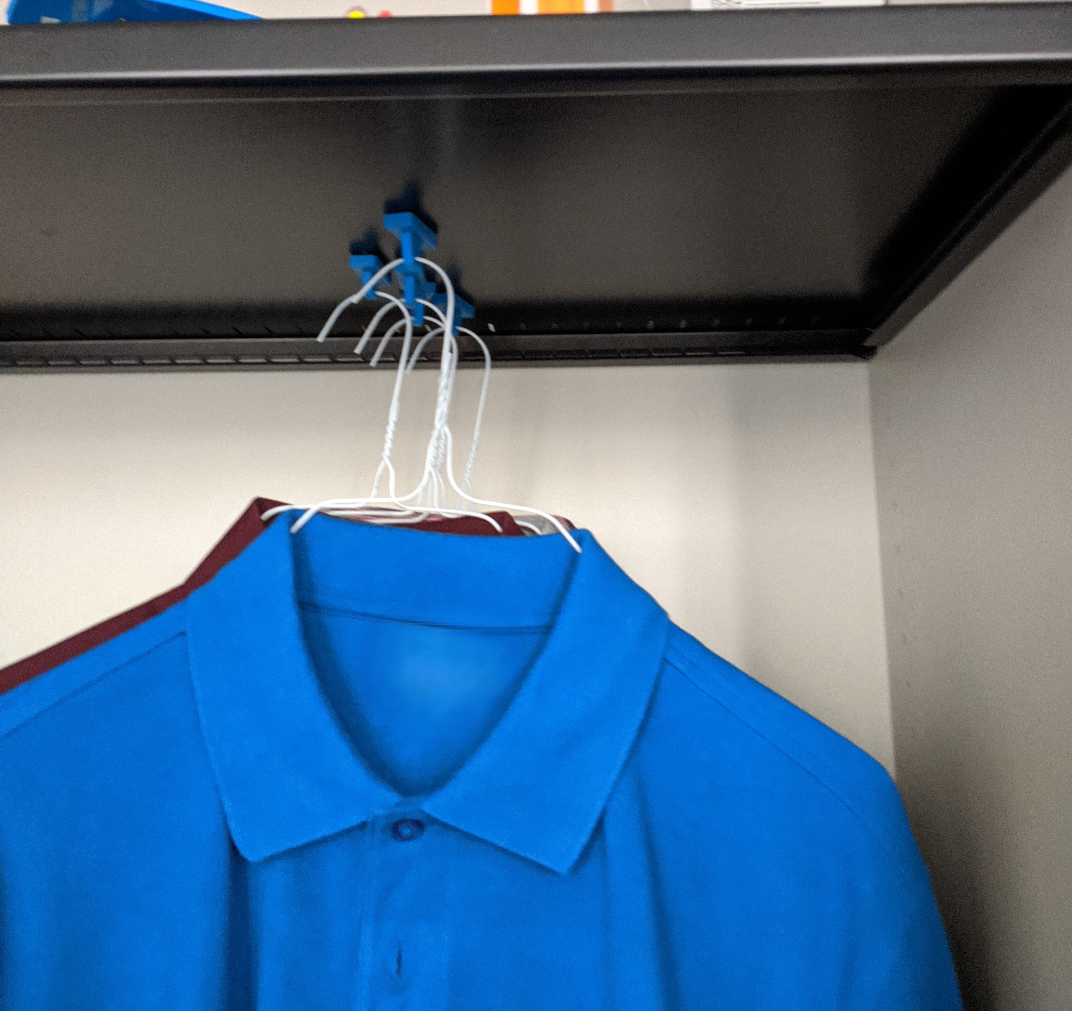 Magnetic eyelet for clothes hangers
