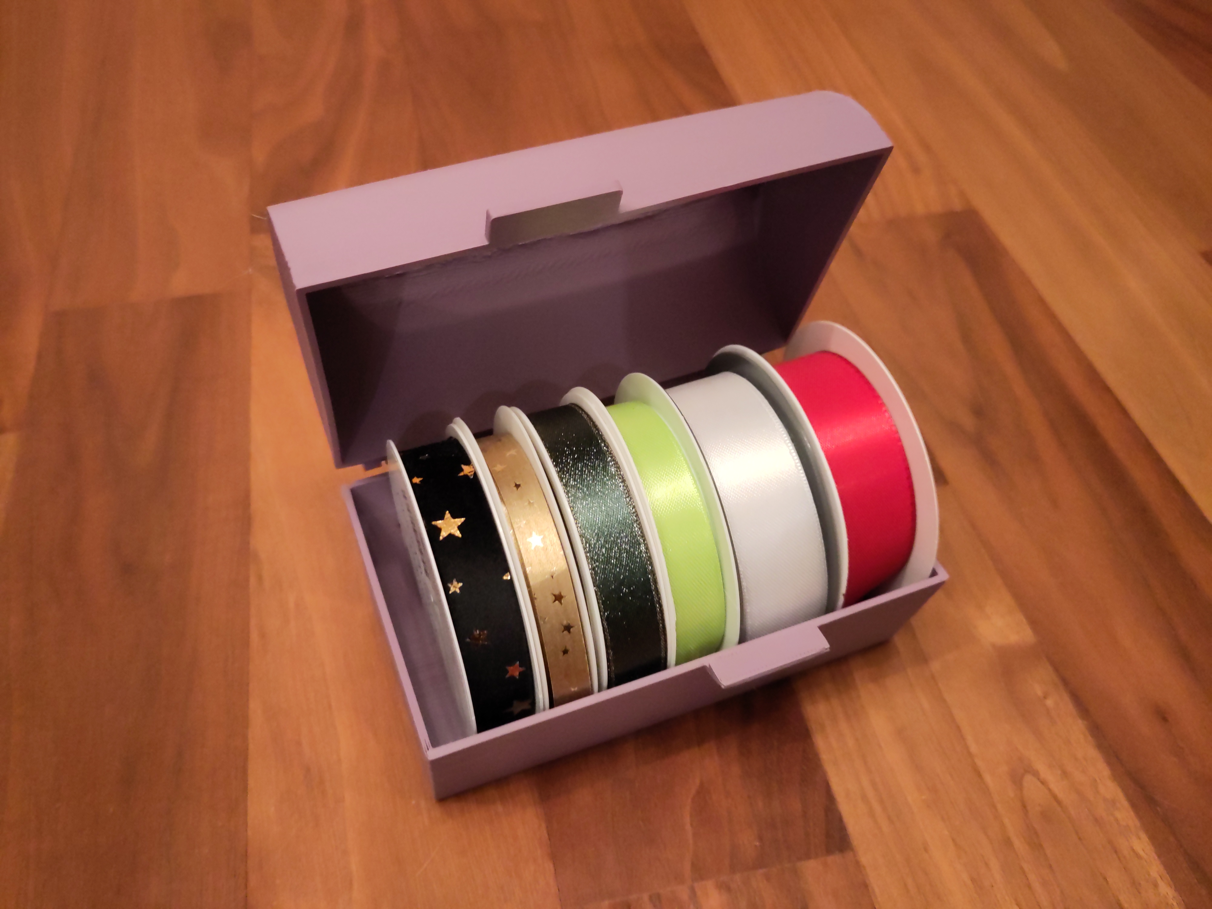 Storage box for gift ribbons
