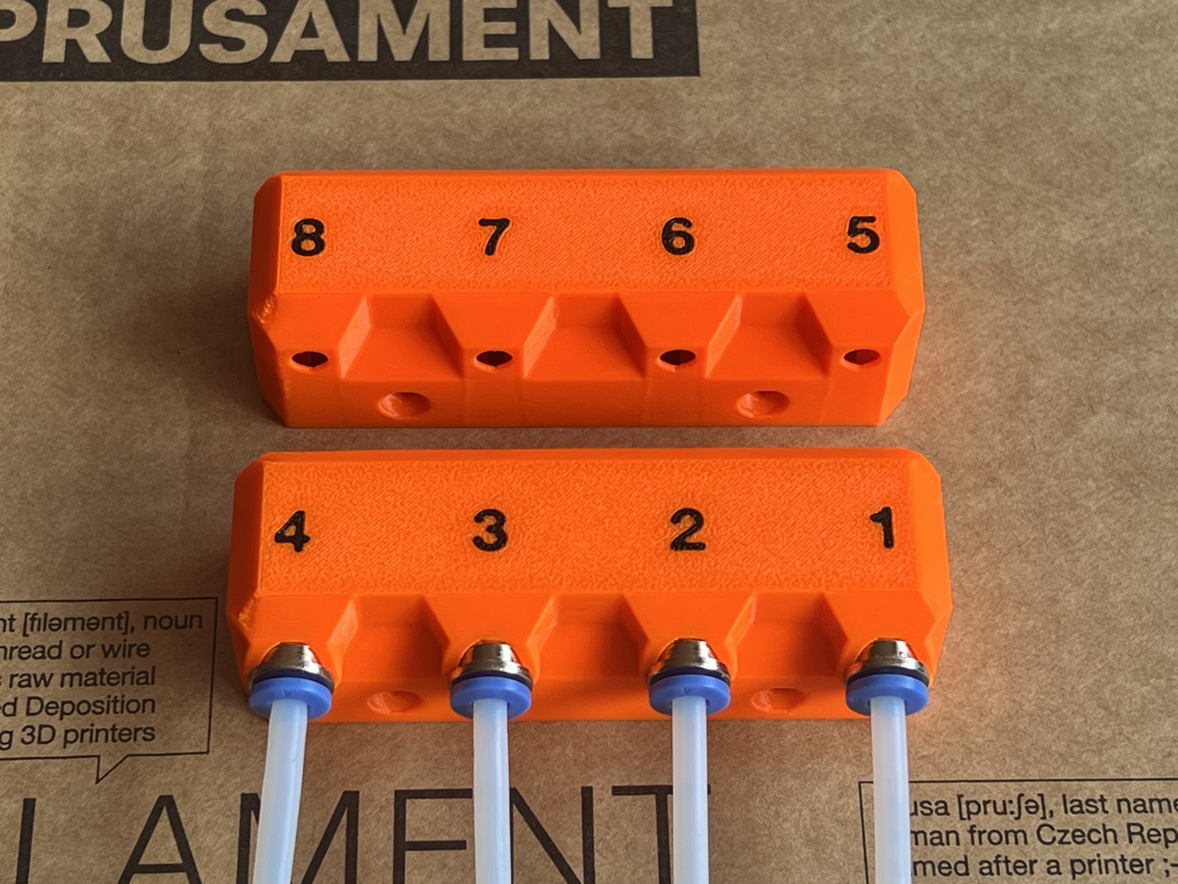Prusa's Bondtech INDX filament sensor body remixed with tool numbers and optional ECAS fittings