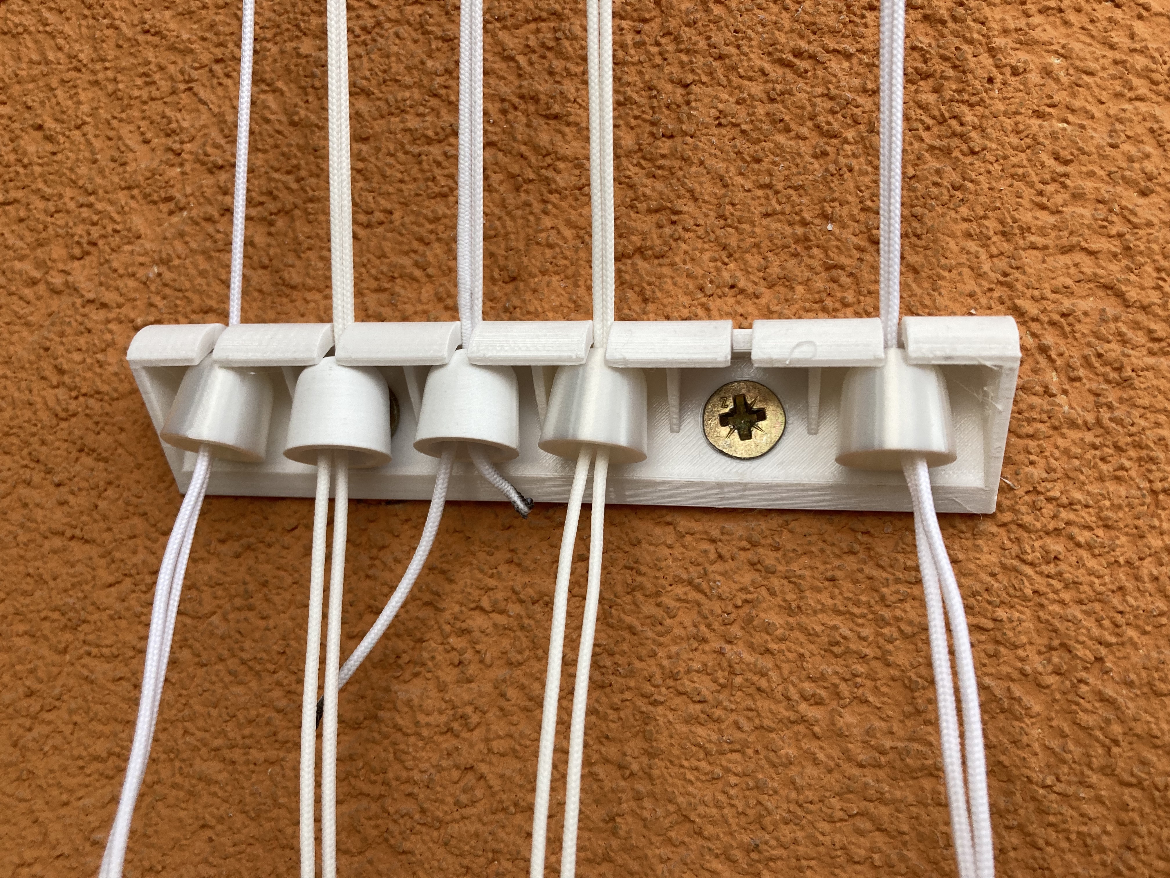 Cord holder for ceiling-mounted clothes dryer