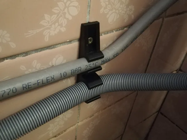 Enhanced washing machine hose holder