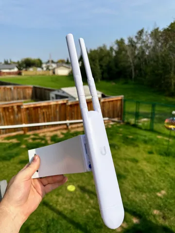 Corner mount for a Ubiquiti UAP-AC-M mesh outdoor access point.