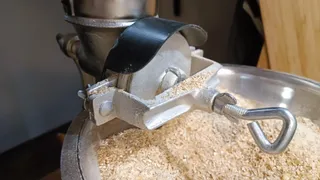 Grain mill spill guard