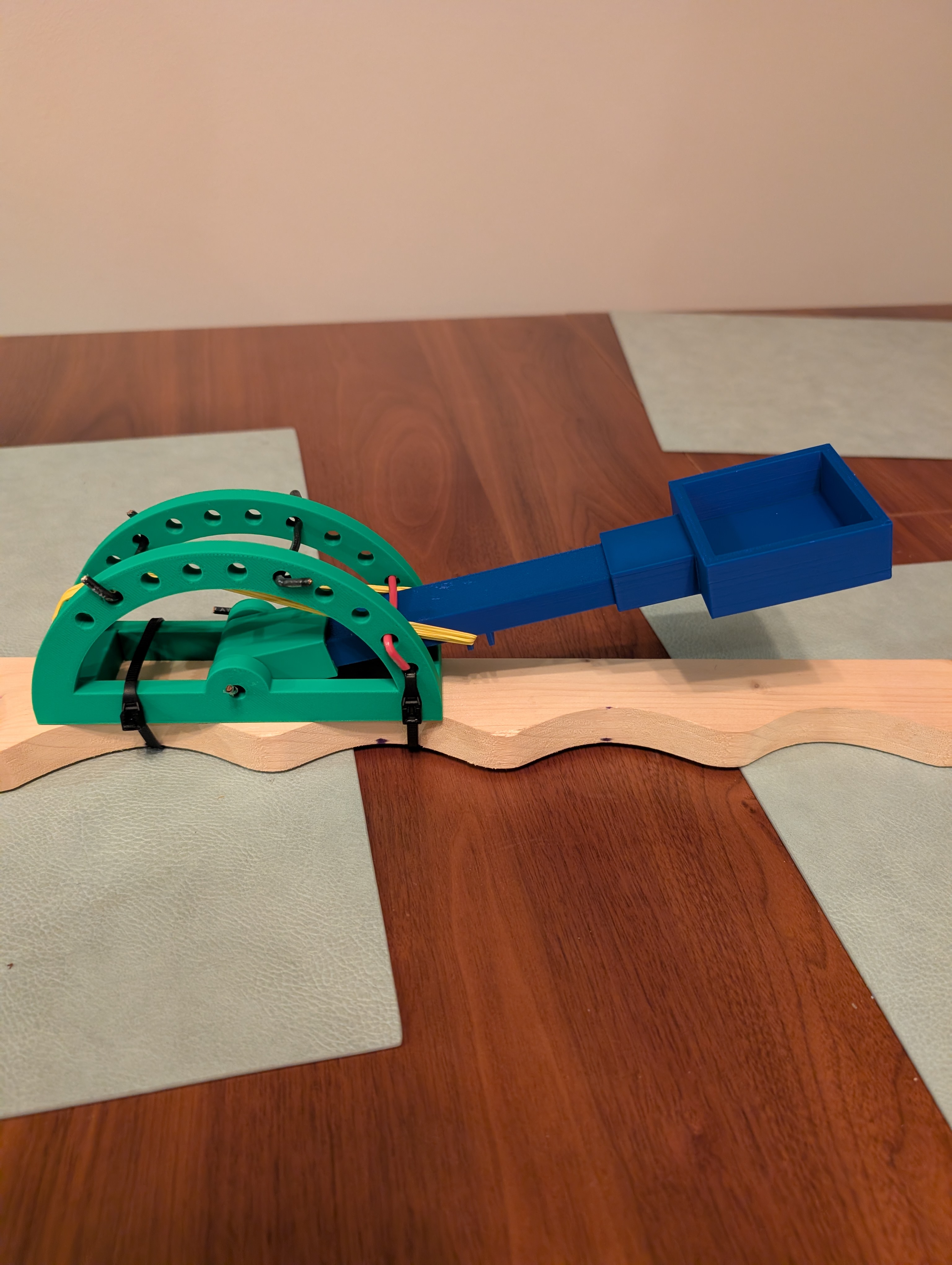 Catapult arm and launch bucket