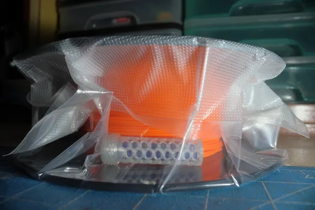 Desiccant container for vacuum seal bags