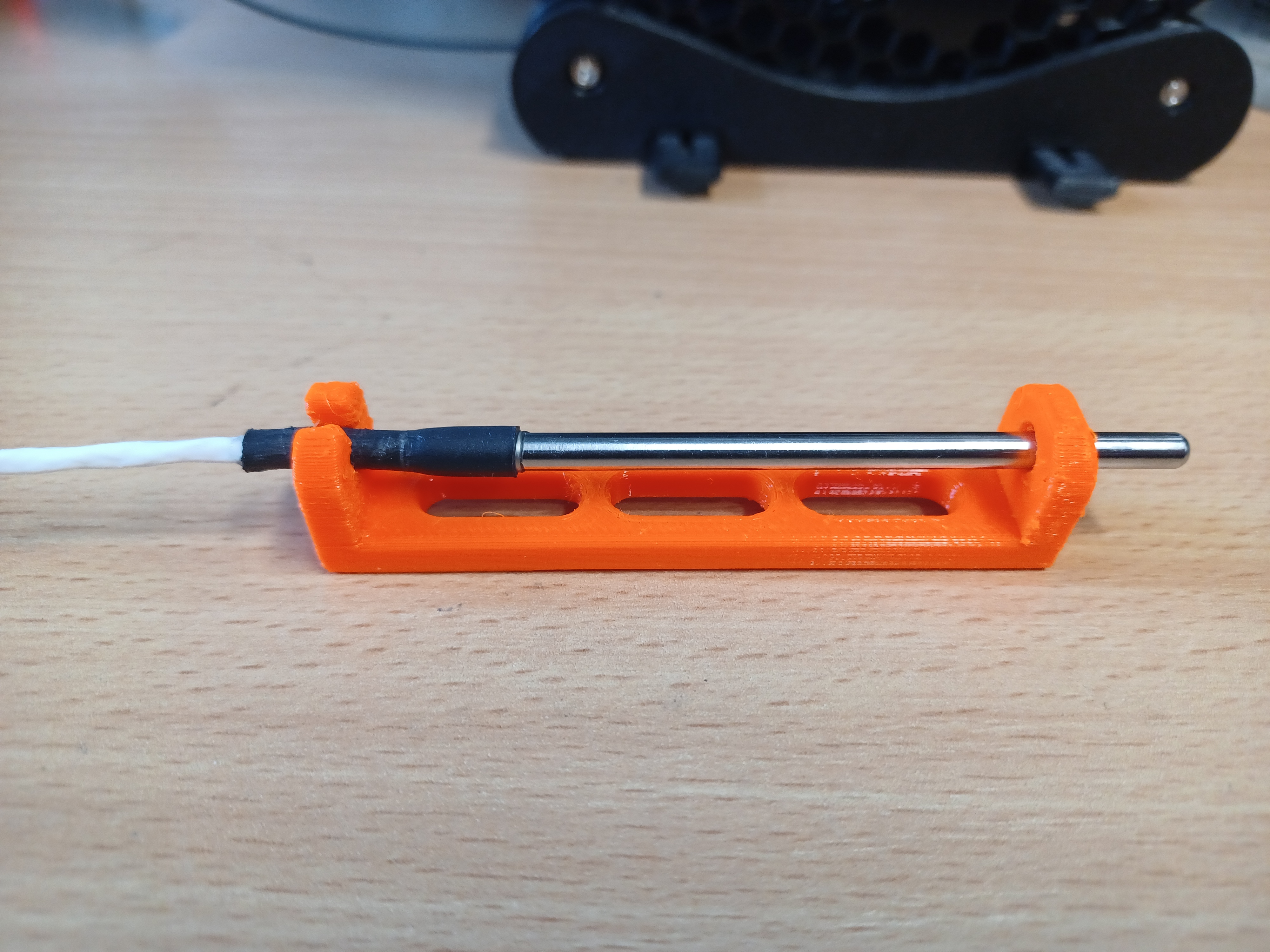 Temperature probe holder for CAM monitoring system
