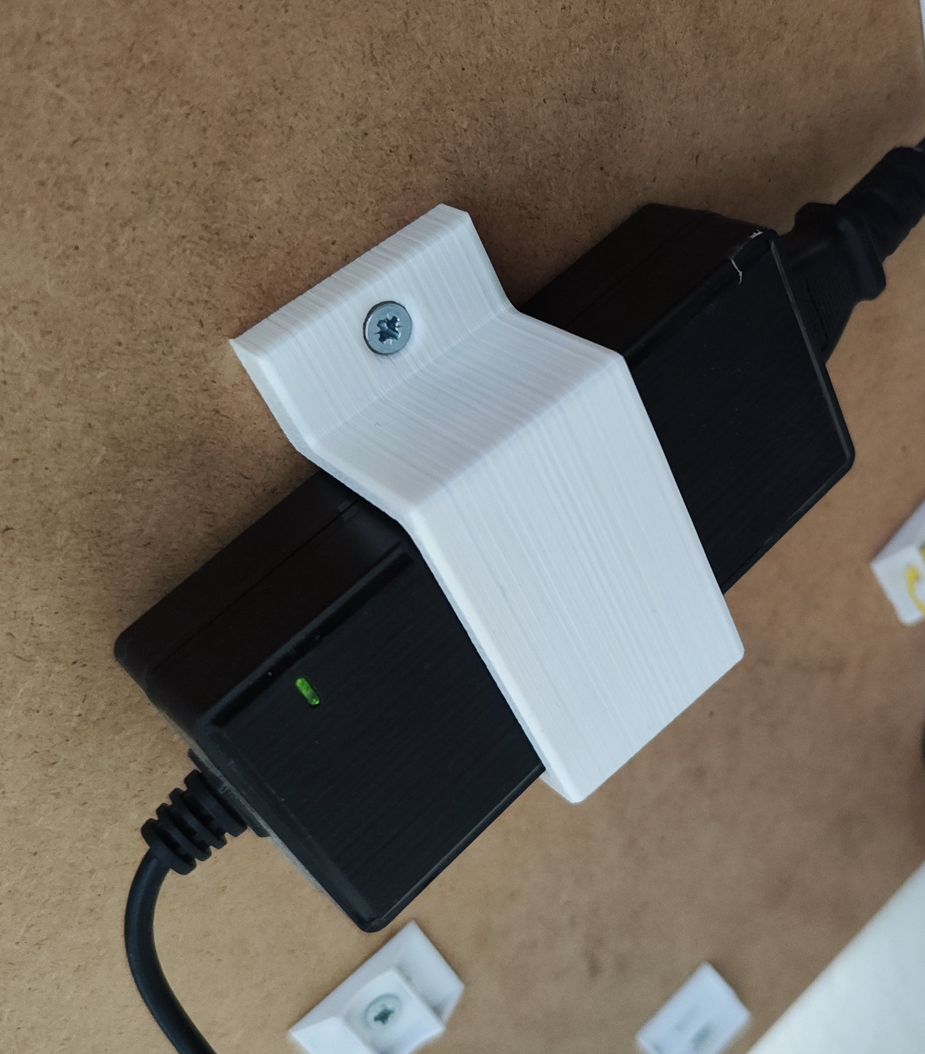 Under desk holder for monitor power adapter