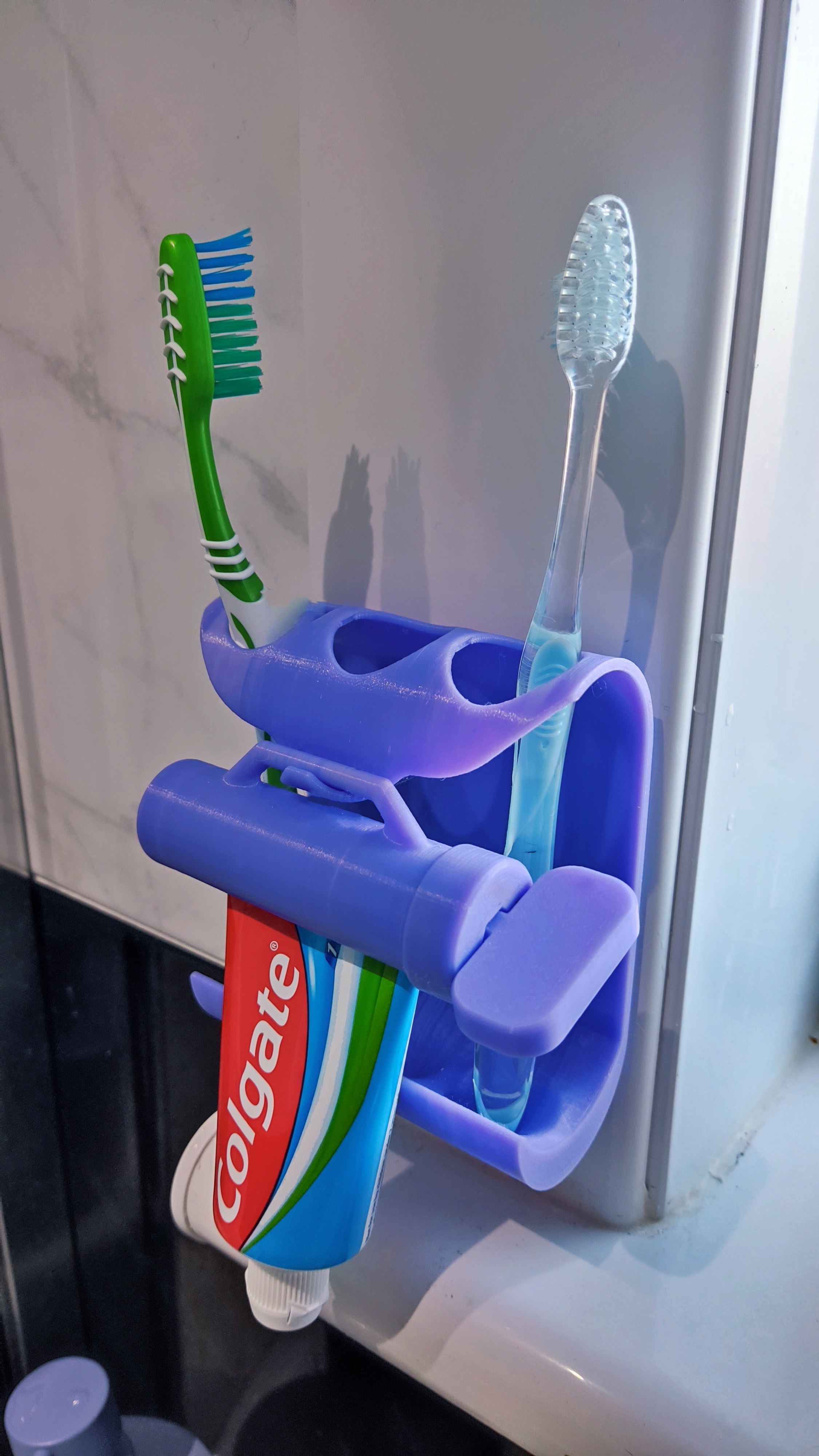 Toothpaste squeezer and toothbrush holder