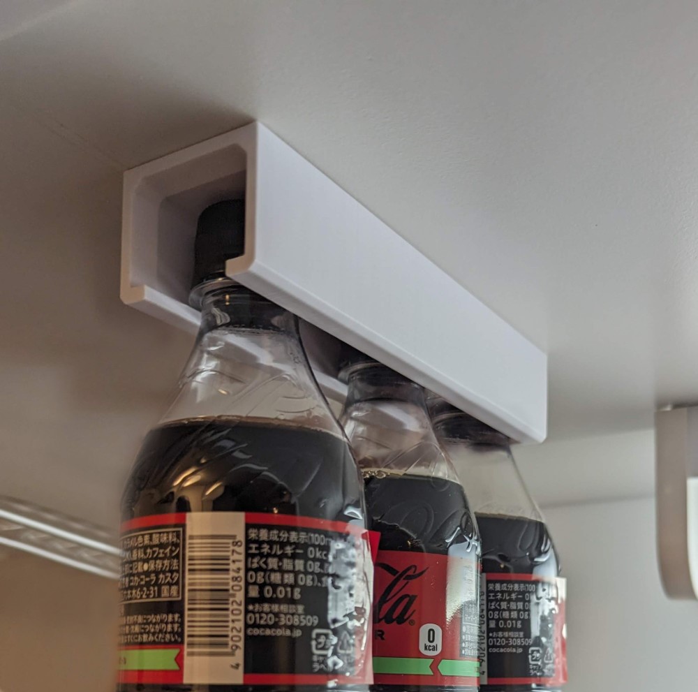 Hanging PET bottle storage with screw holes for affixing anywhere (fits on small printers)
