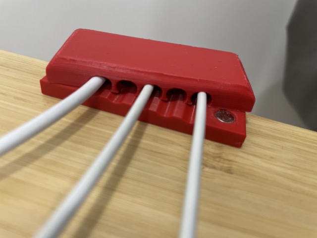 Magnetic cable organizer for desk with clamps