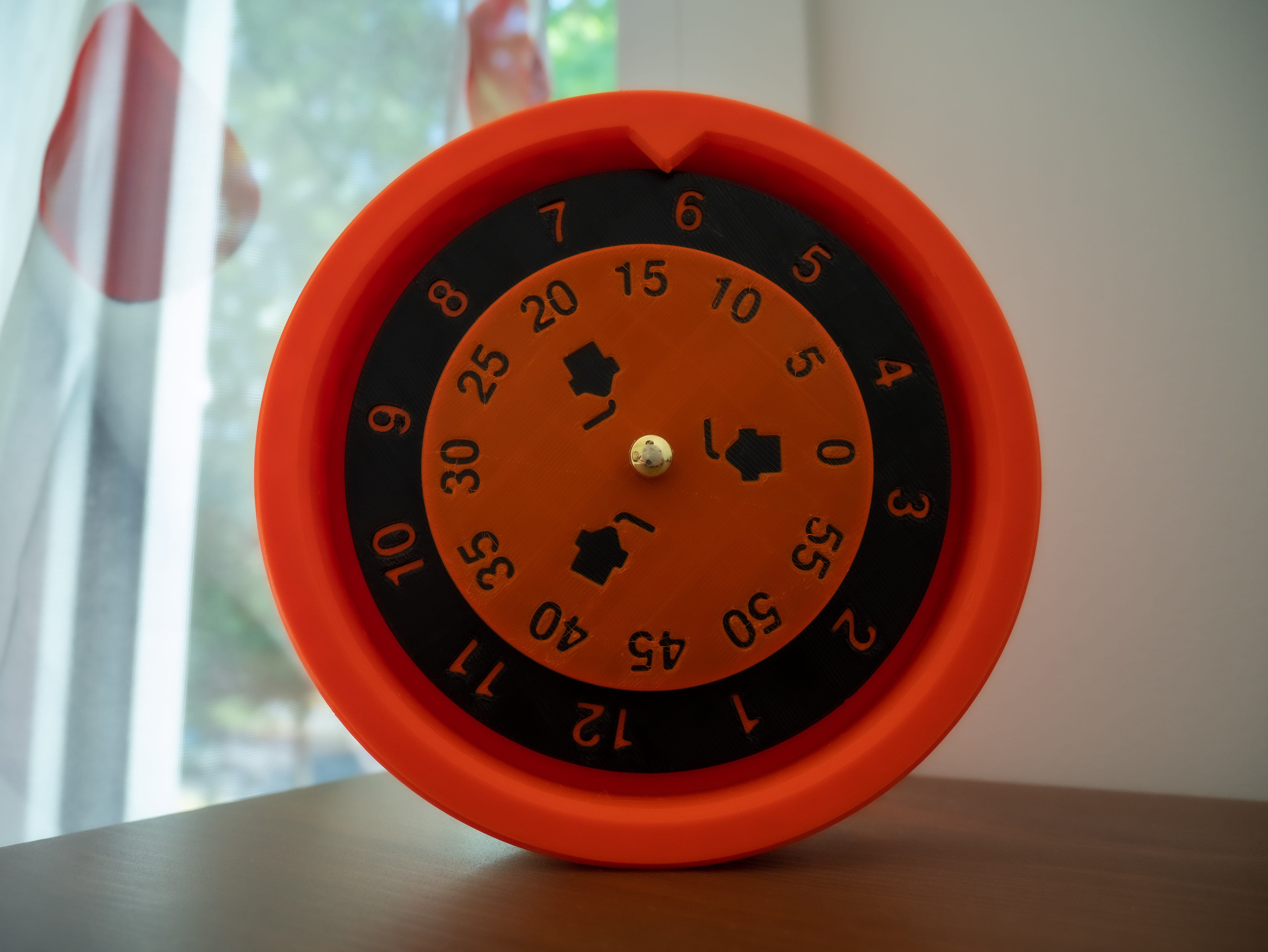 Reverse logic clock with rotating dial and fixed hand