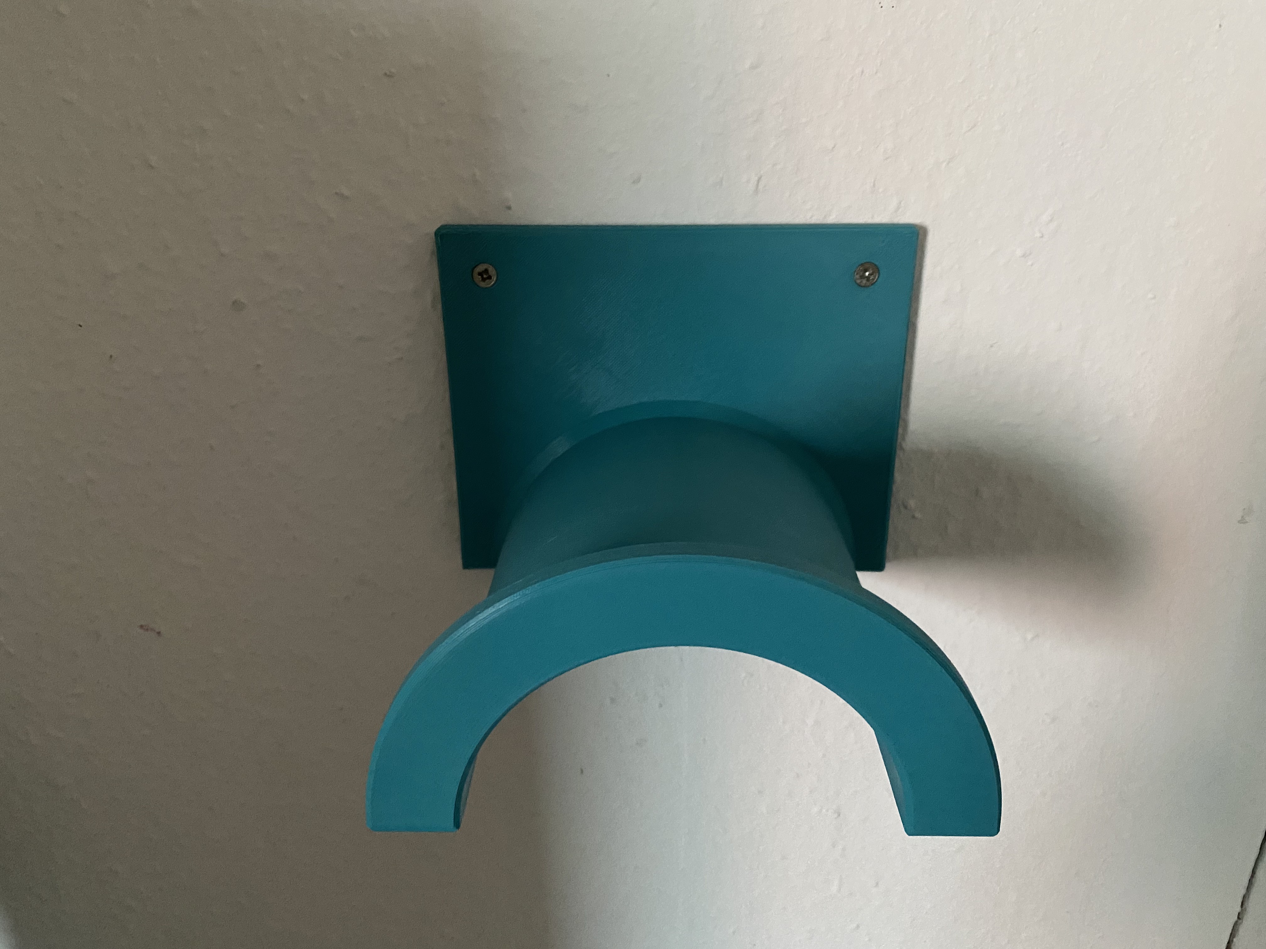 Wallmounted holder for hoses or cables