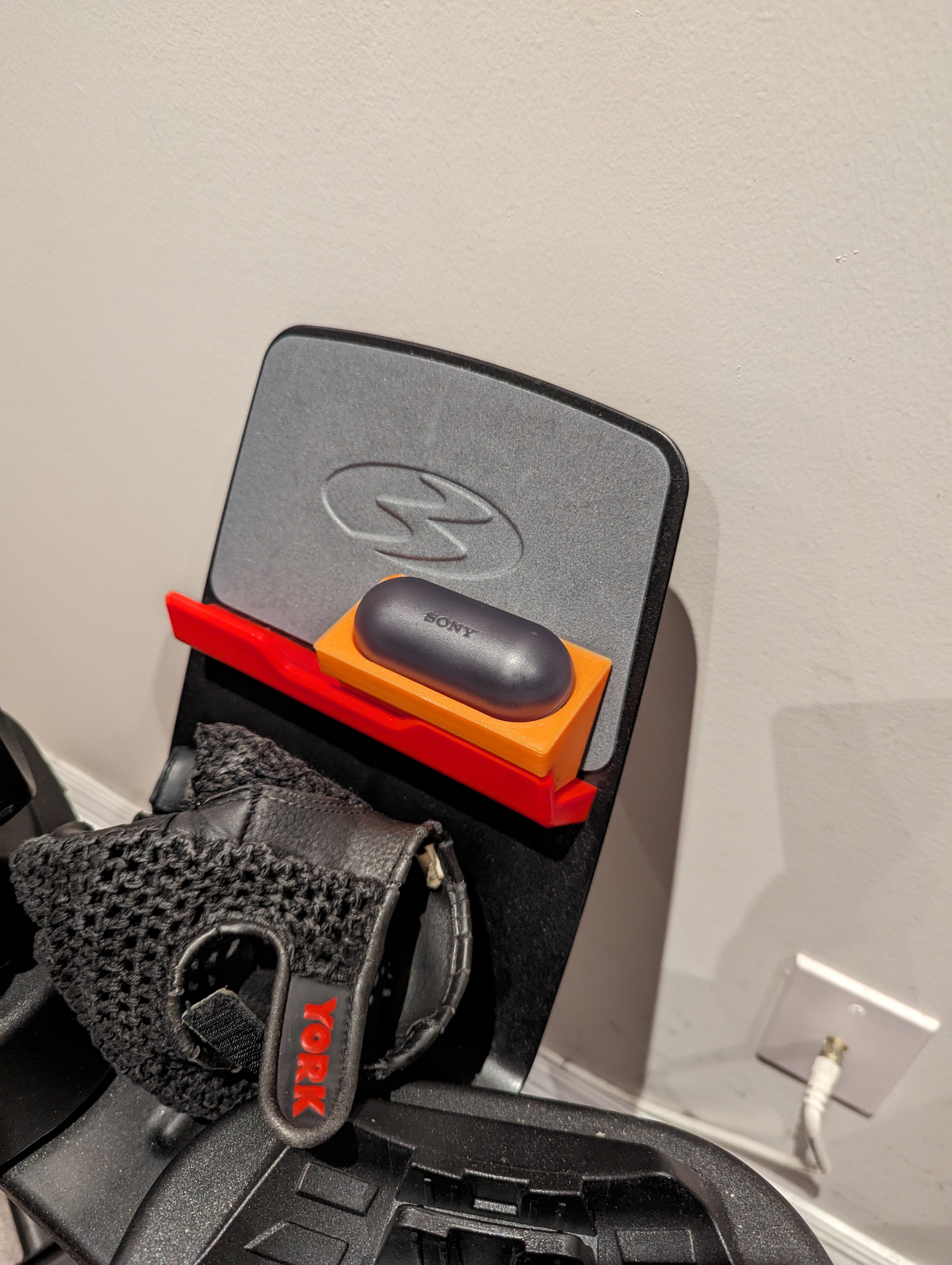 Earbuds holder for Bowflex dumbbells stand