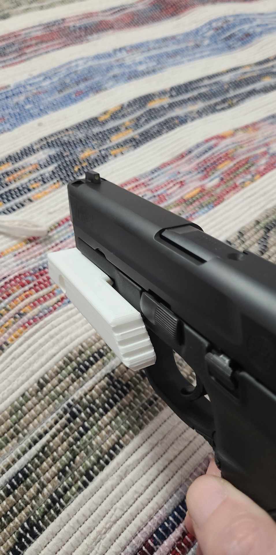 thumb rest for picatinny front rail on a pistol by François Dubeau