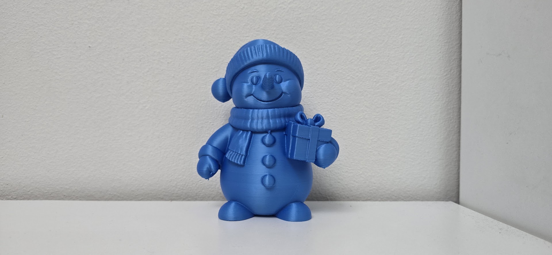 Smiling Snowman with Gift and Scarf Christmas Figurine