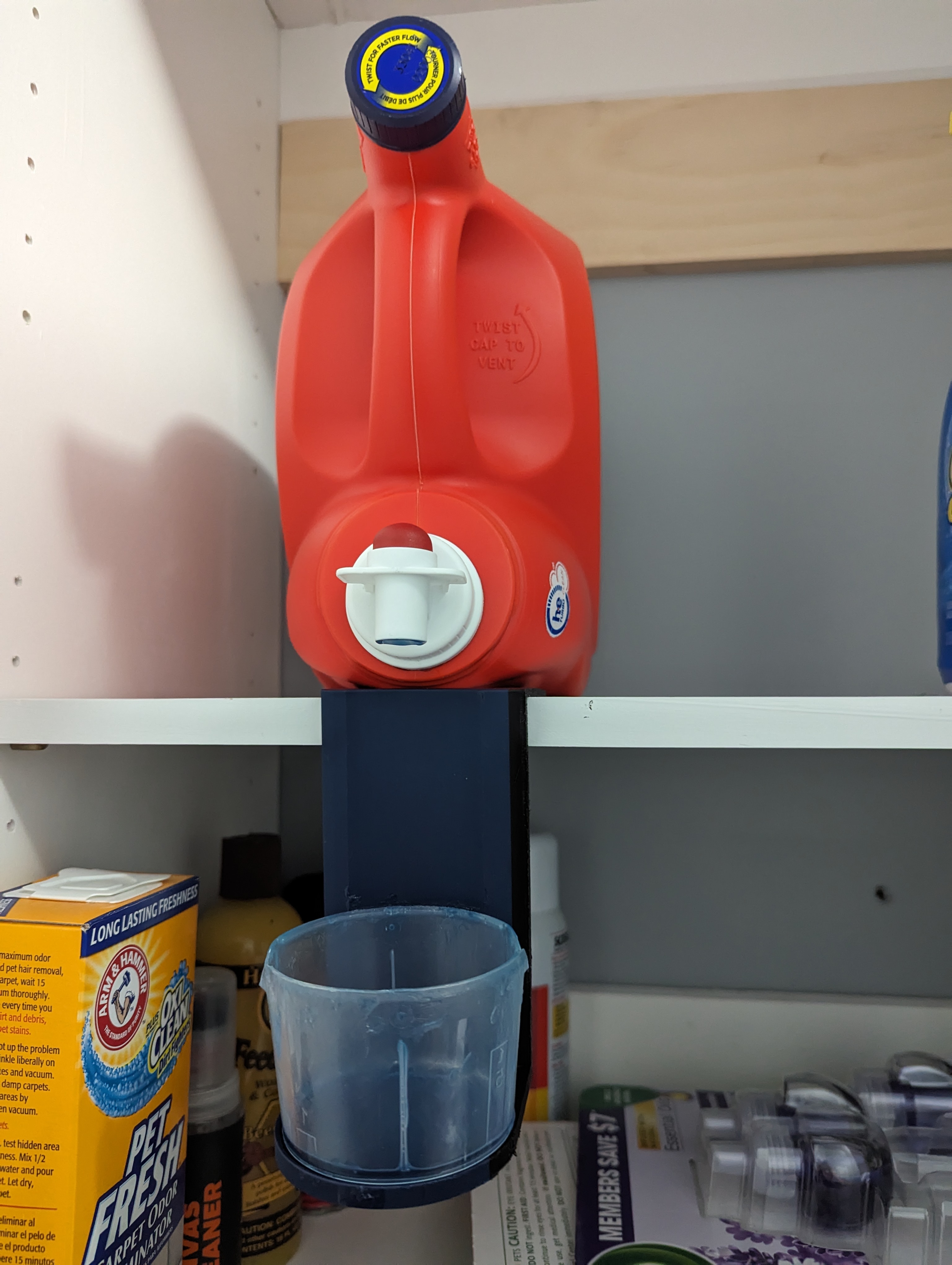 Small shelf mounted liquid laundry detergent cup holder by Keith