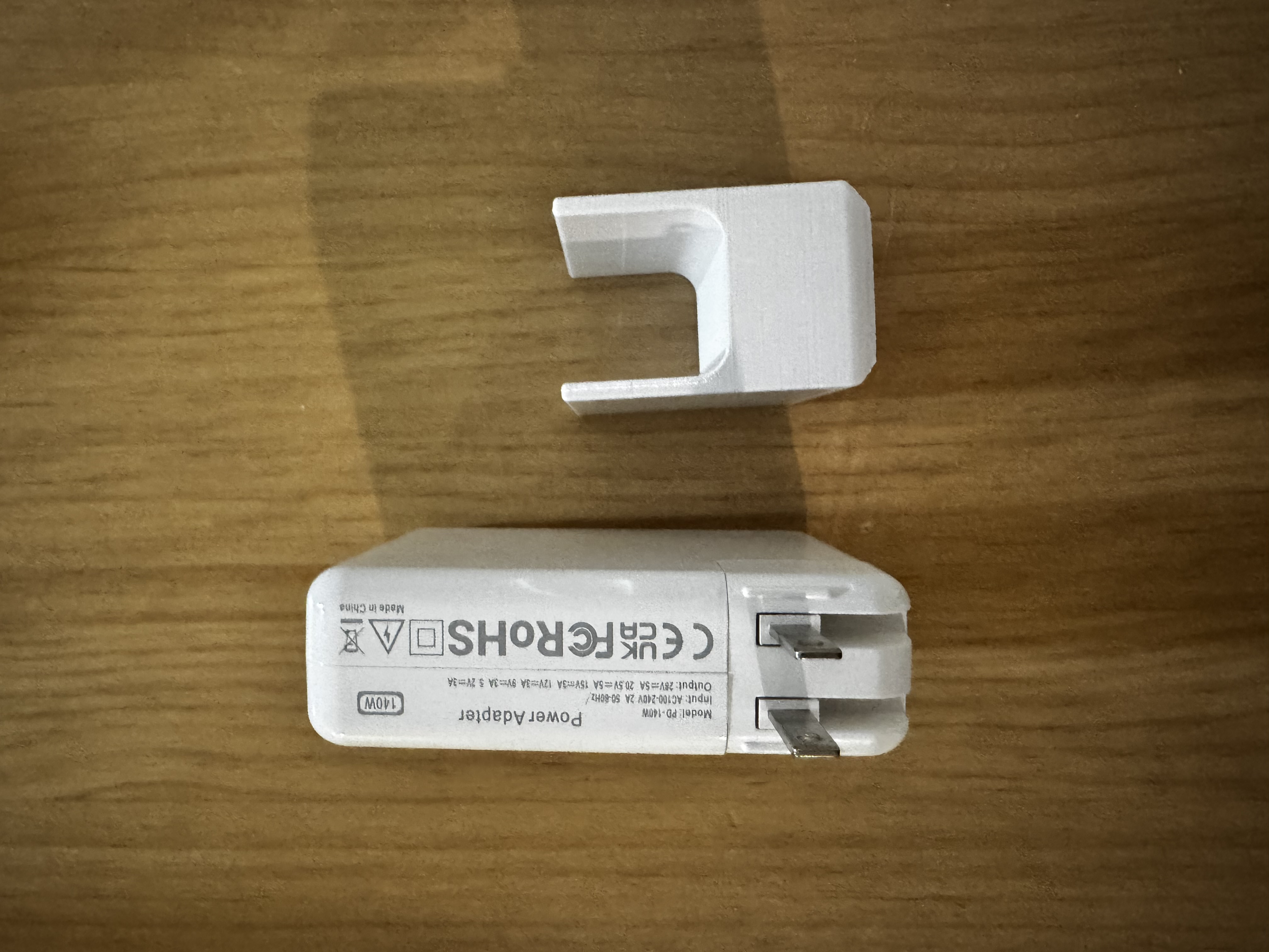 A support stand for a MacBook Pro power adapter