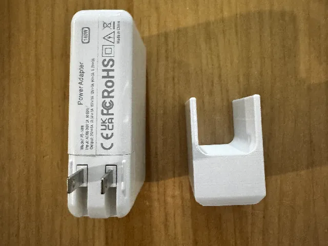 A support stand for a MacBook Pro power adapter