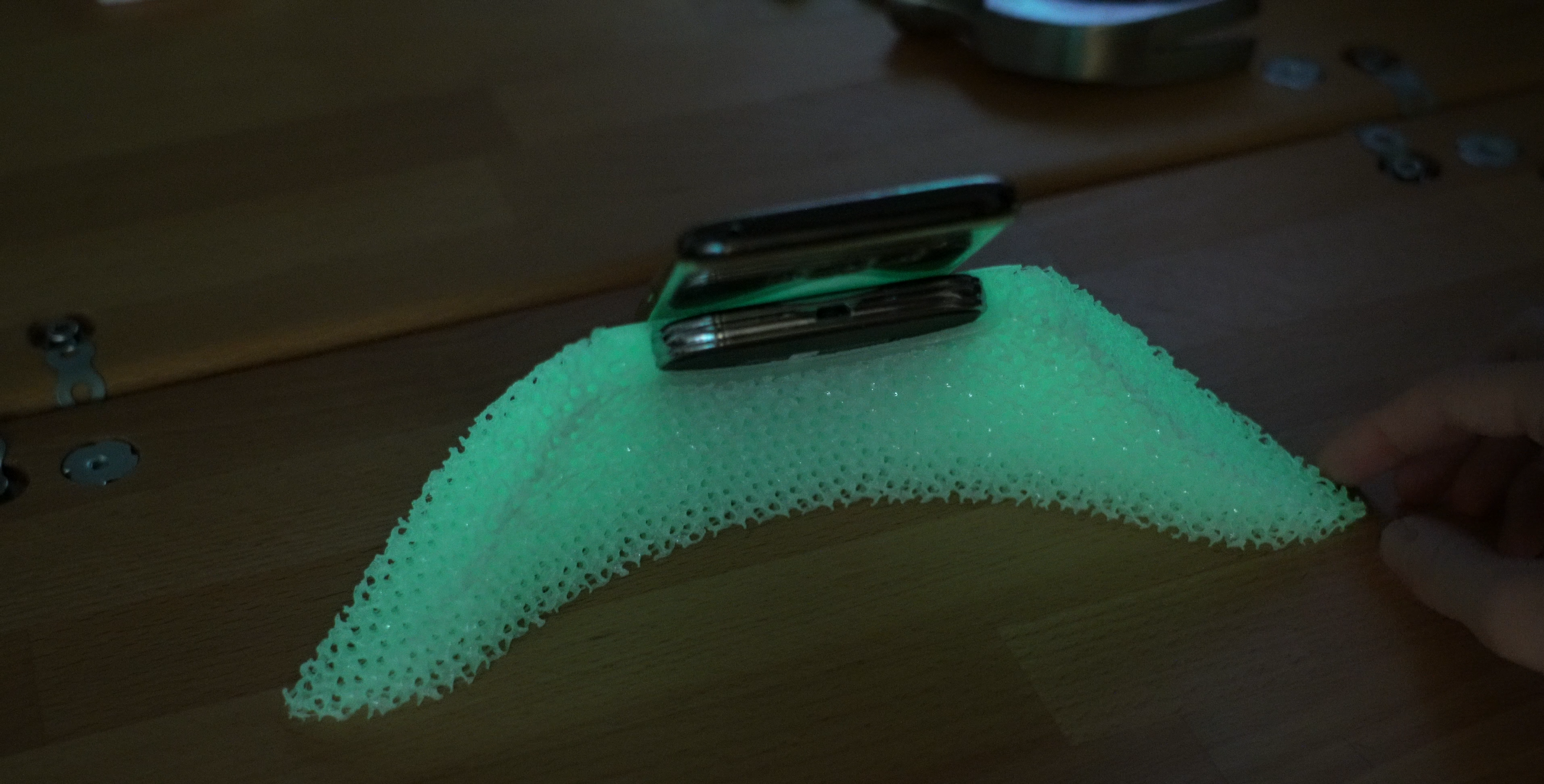 Qi charger desk stand/placement aid that glows in the dark