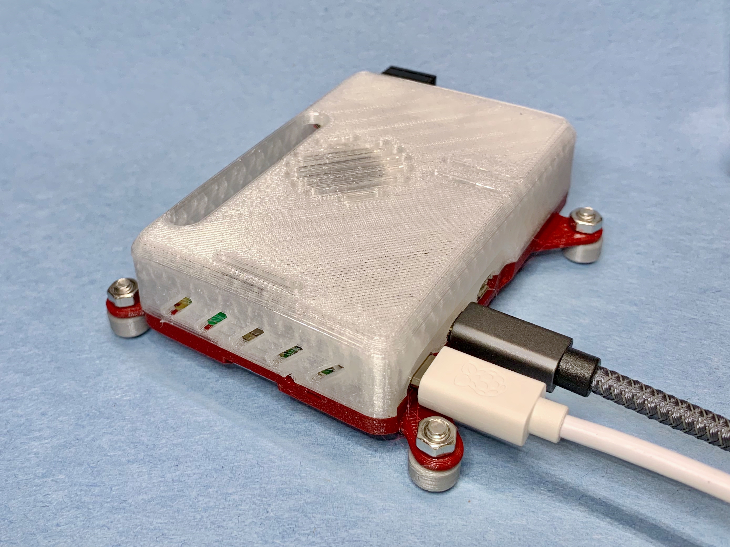 Remix of Raspberry Pi 5 case adding VESA 75 x 75mm mounting tabs