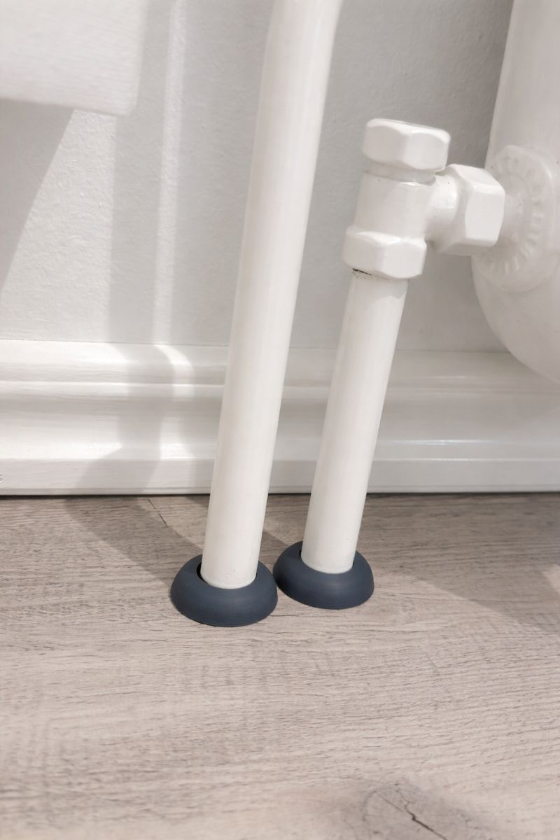 Two-piece radiator pipe cover cap.
