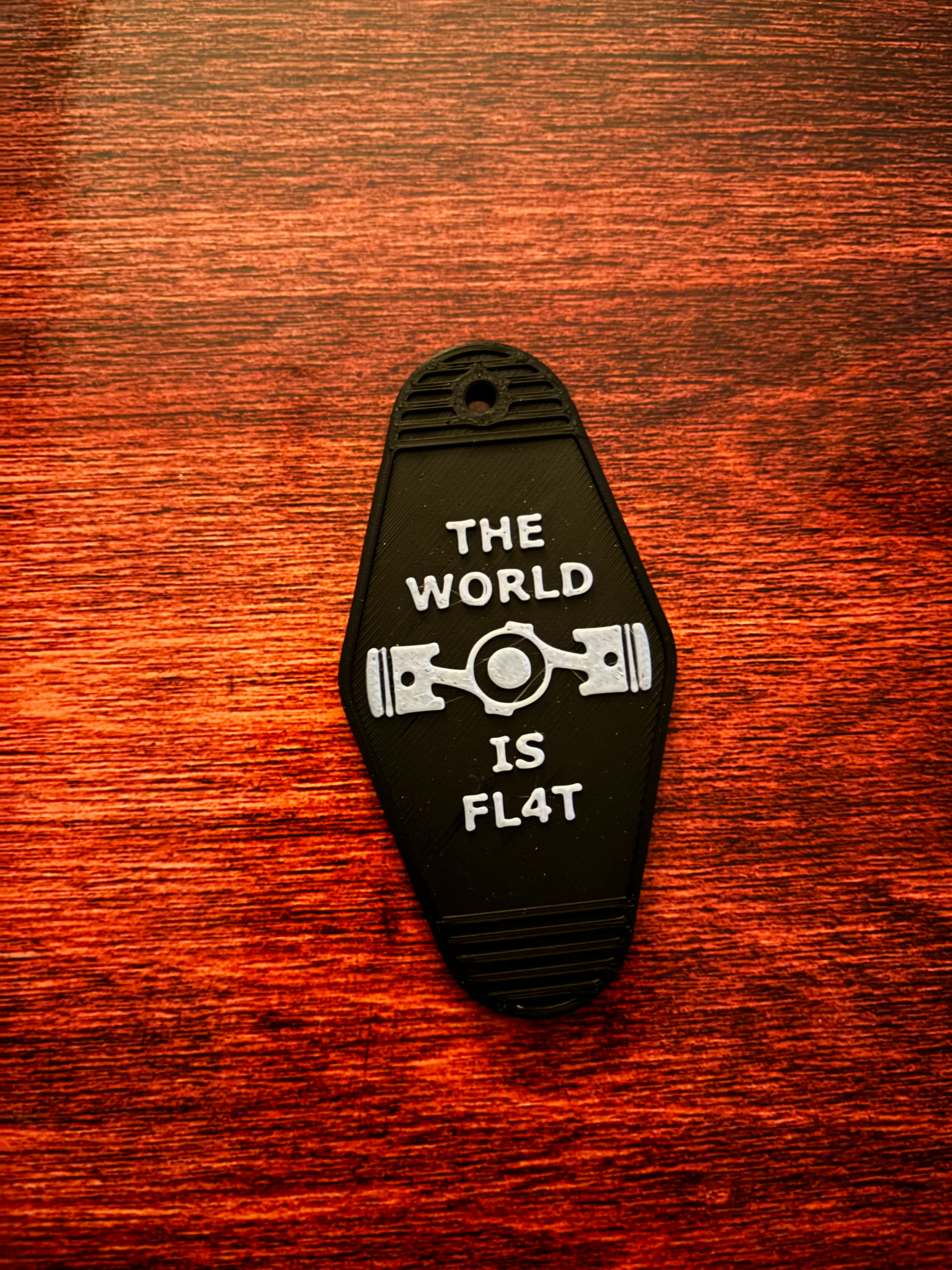 Subaru "The world is flat" hotel keychain