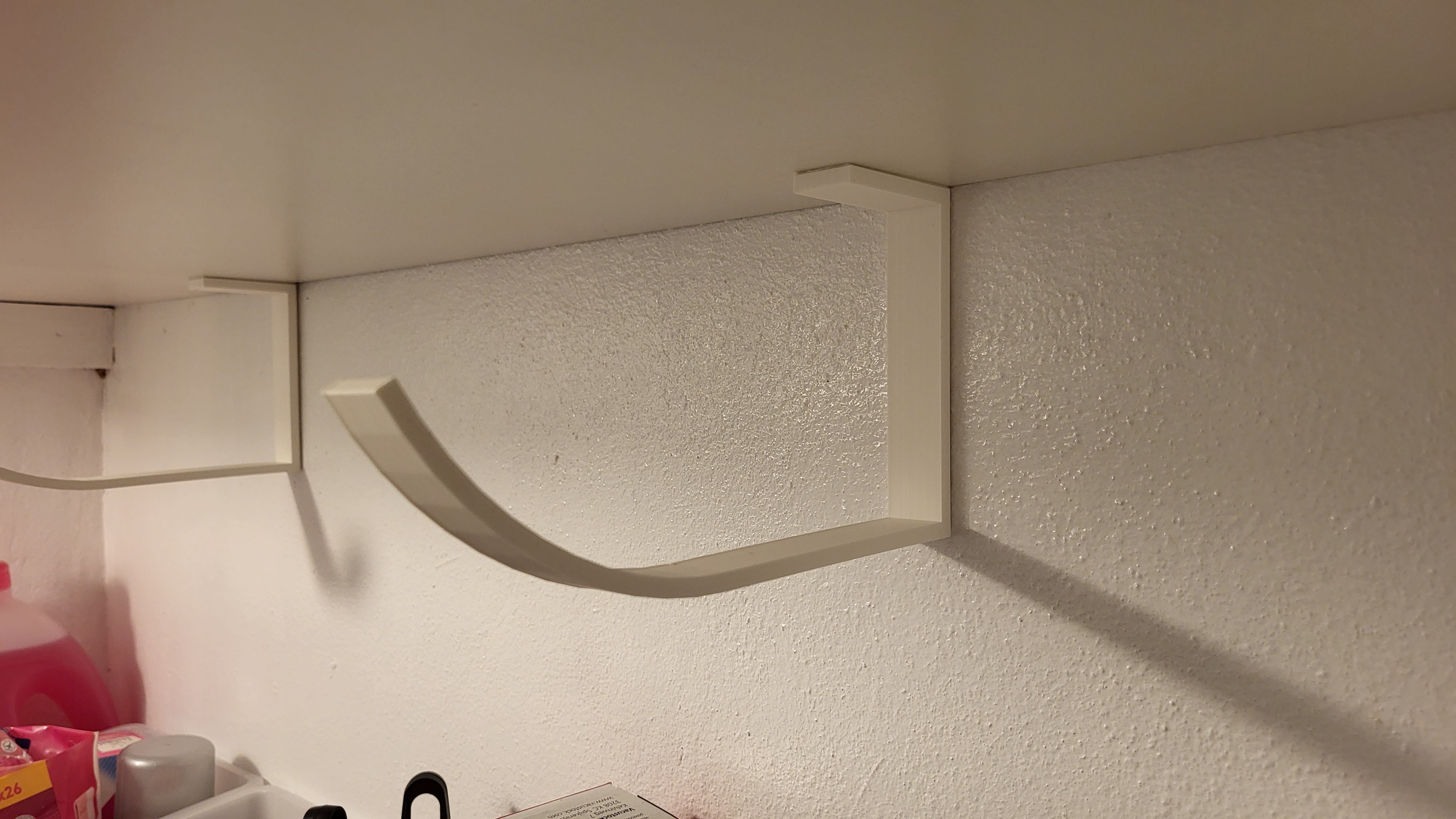 A hook to store things under a shelf