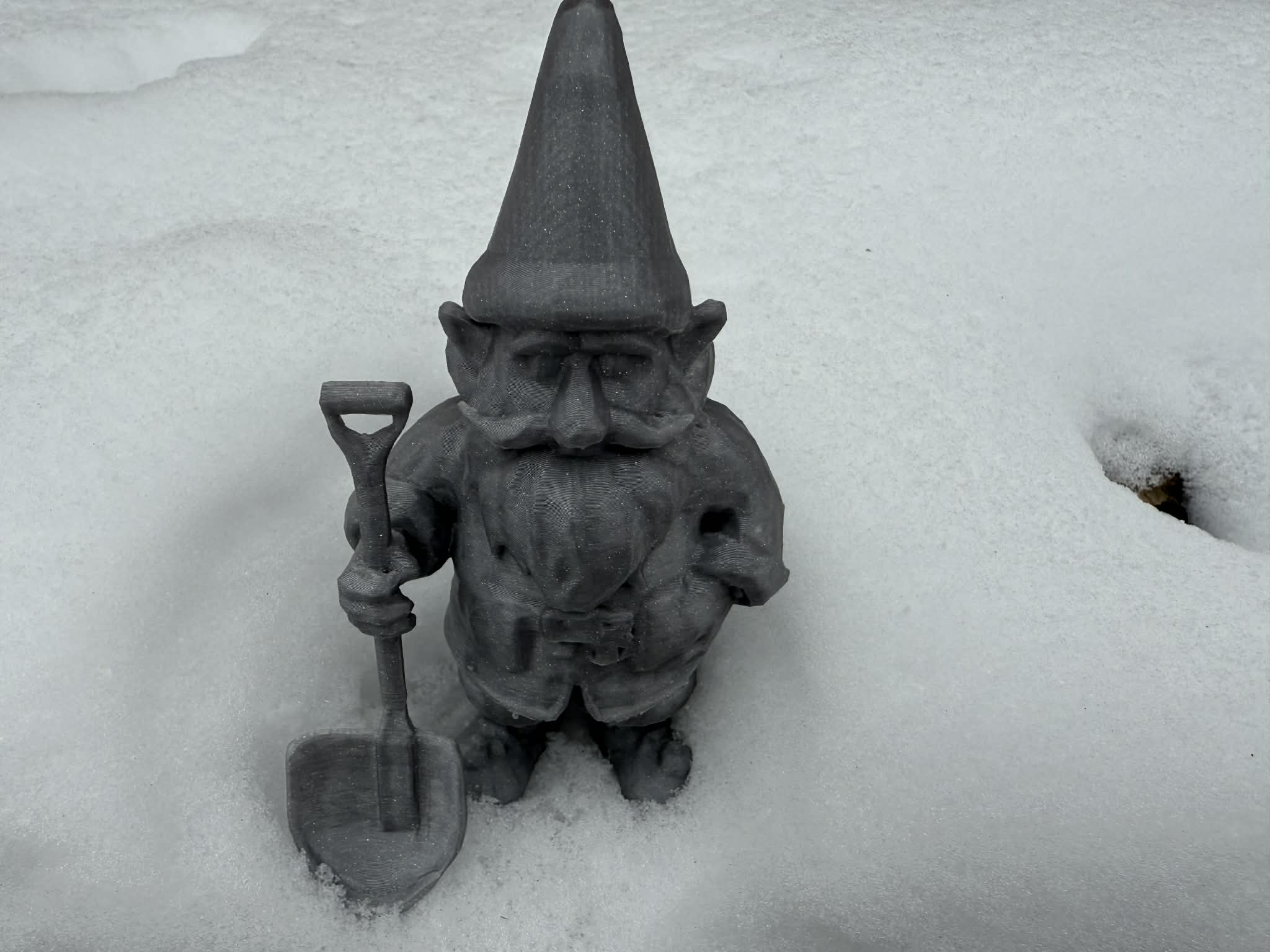 Winter dwarf, gnome, hobbit with snow shovel