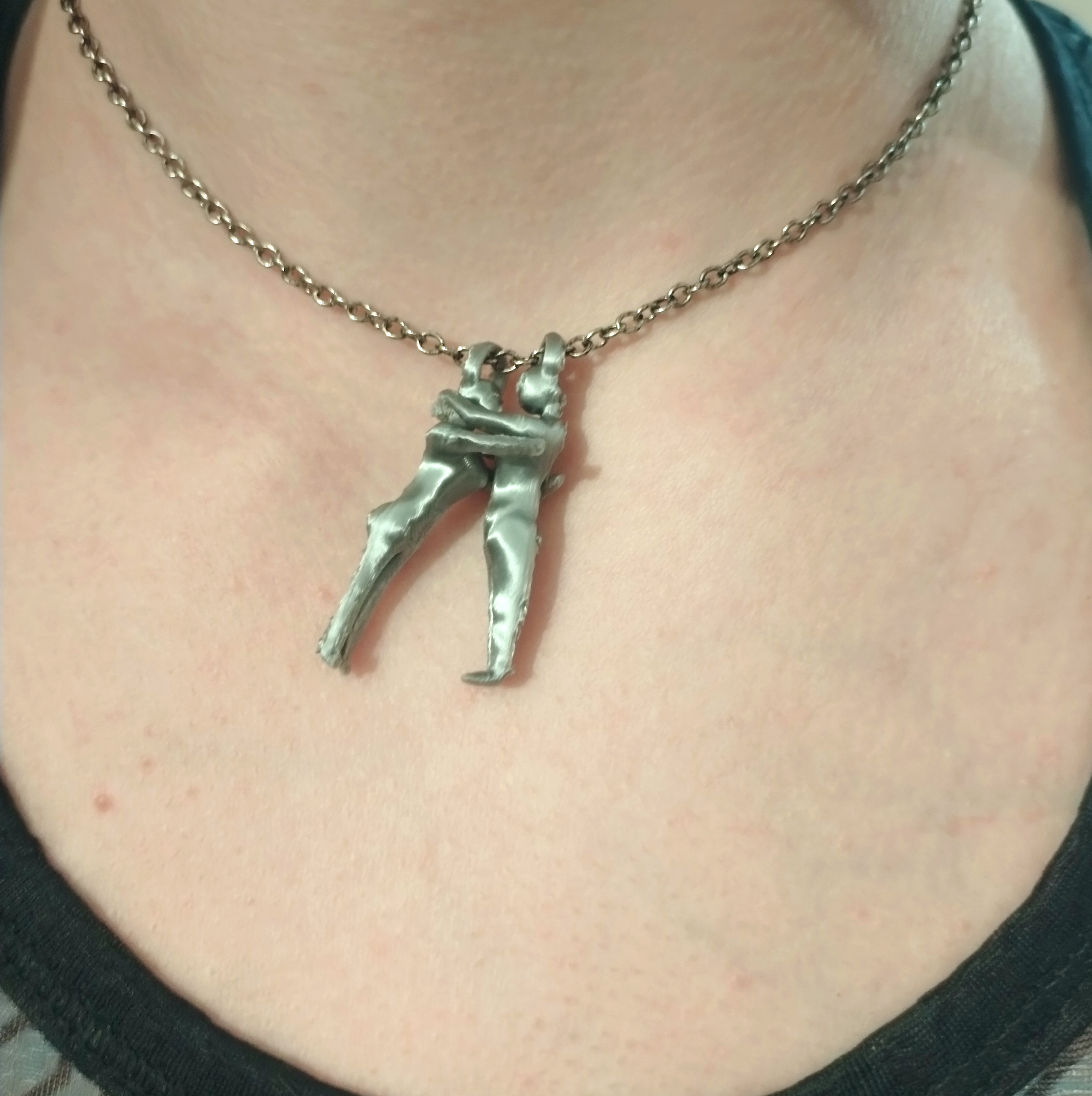 Necklace of a couple hugging together (jewelry)