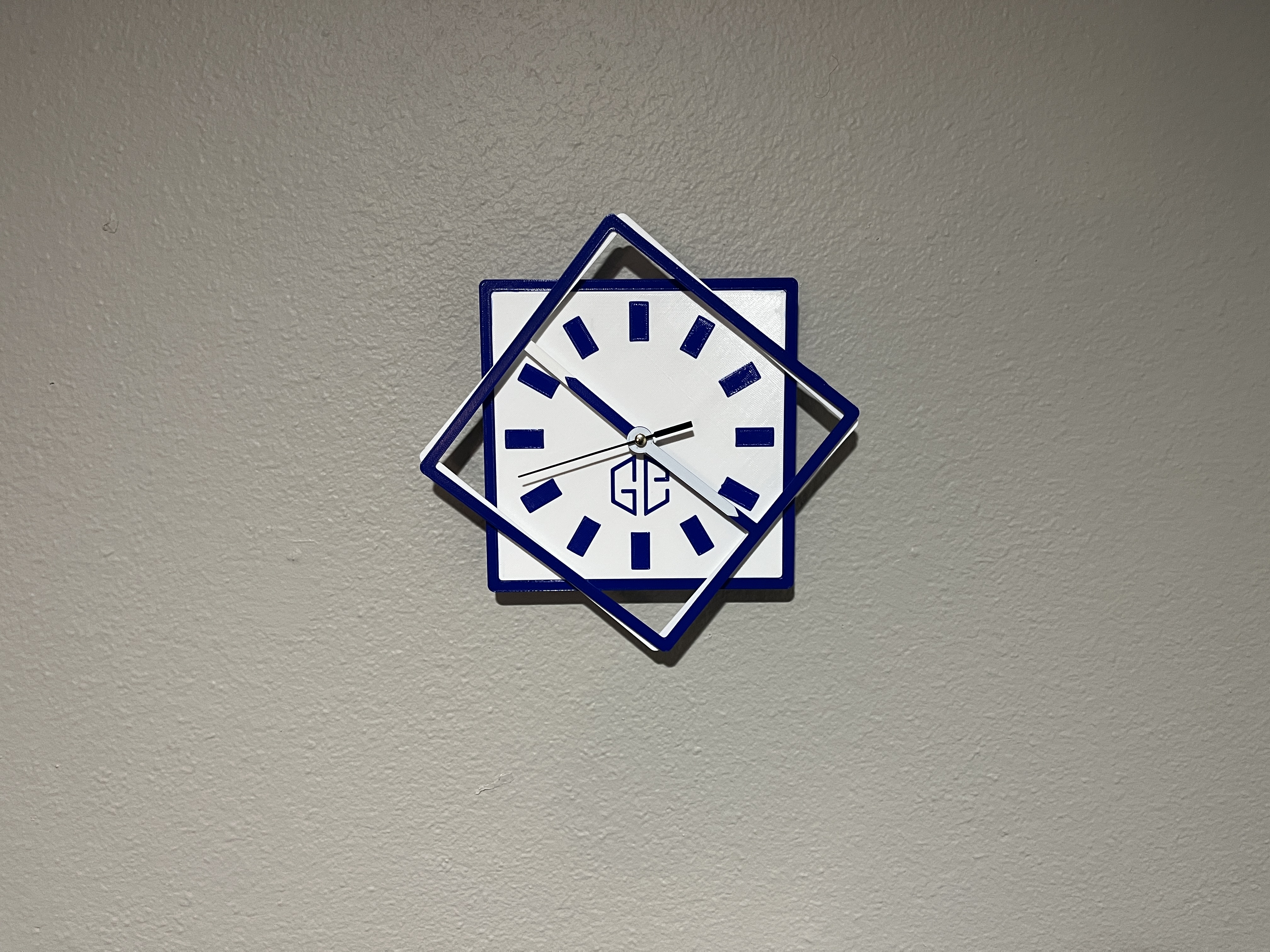 Square clock with square rotating arms
