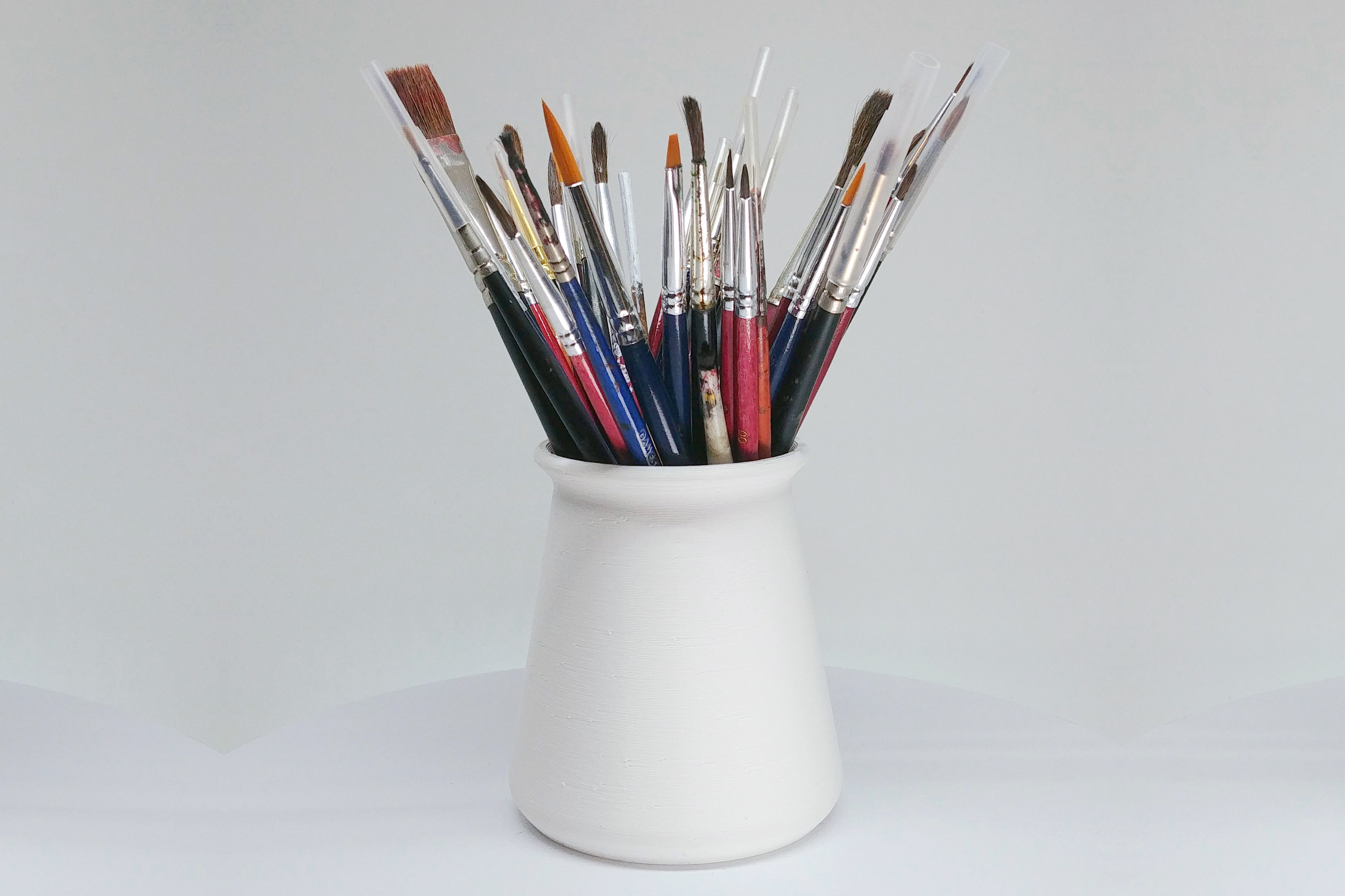 Brushes, pens, screwdrivers, ..., holder vase