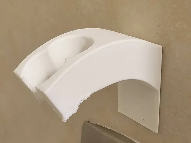 Shower head holder with adhesive backing