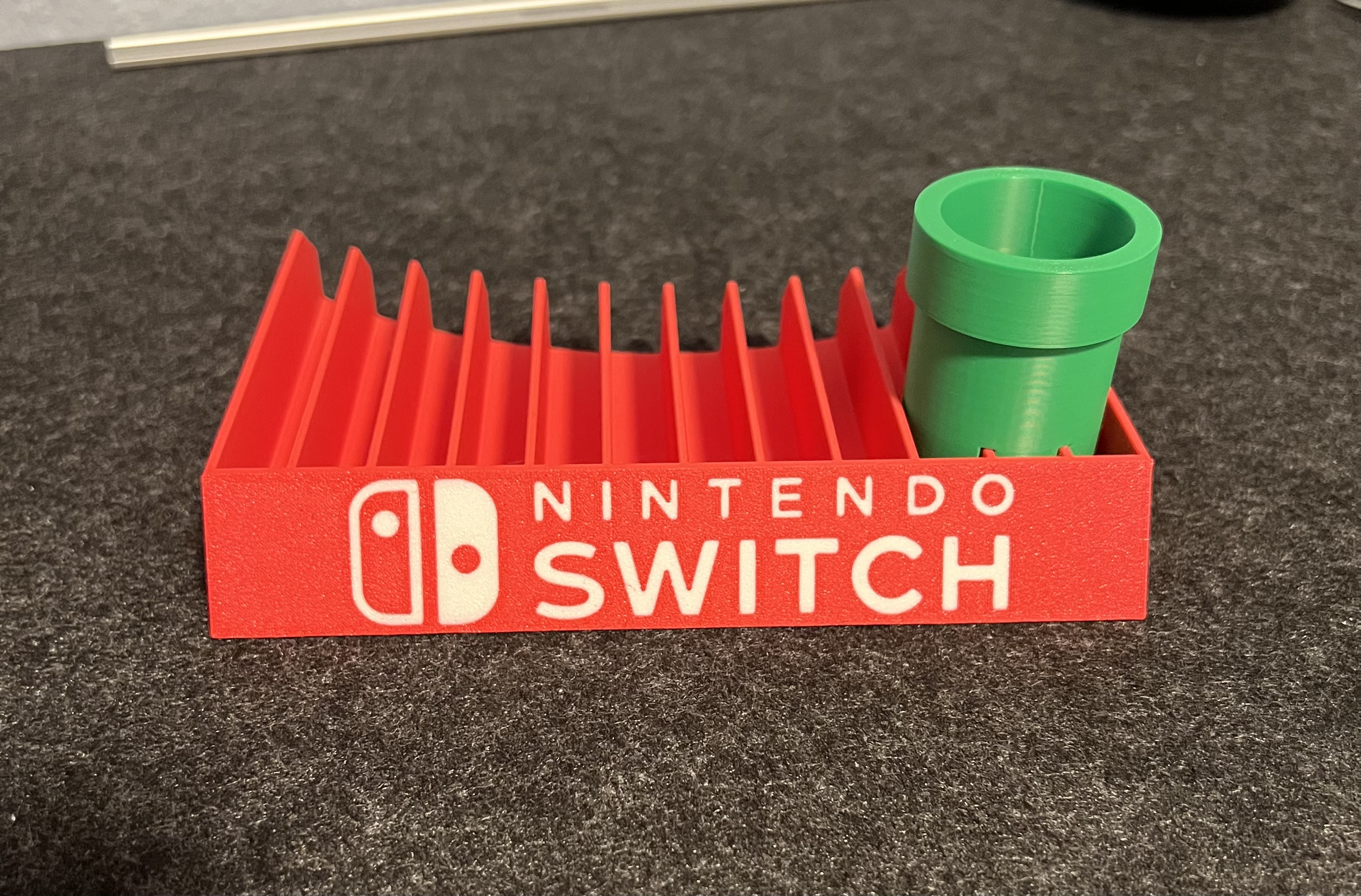 Nintendo Switch game holder with embedded logo and pipe by Sven