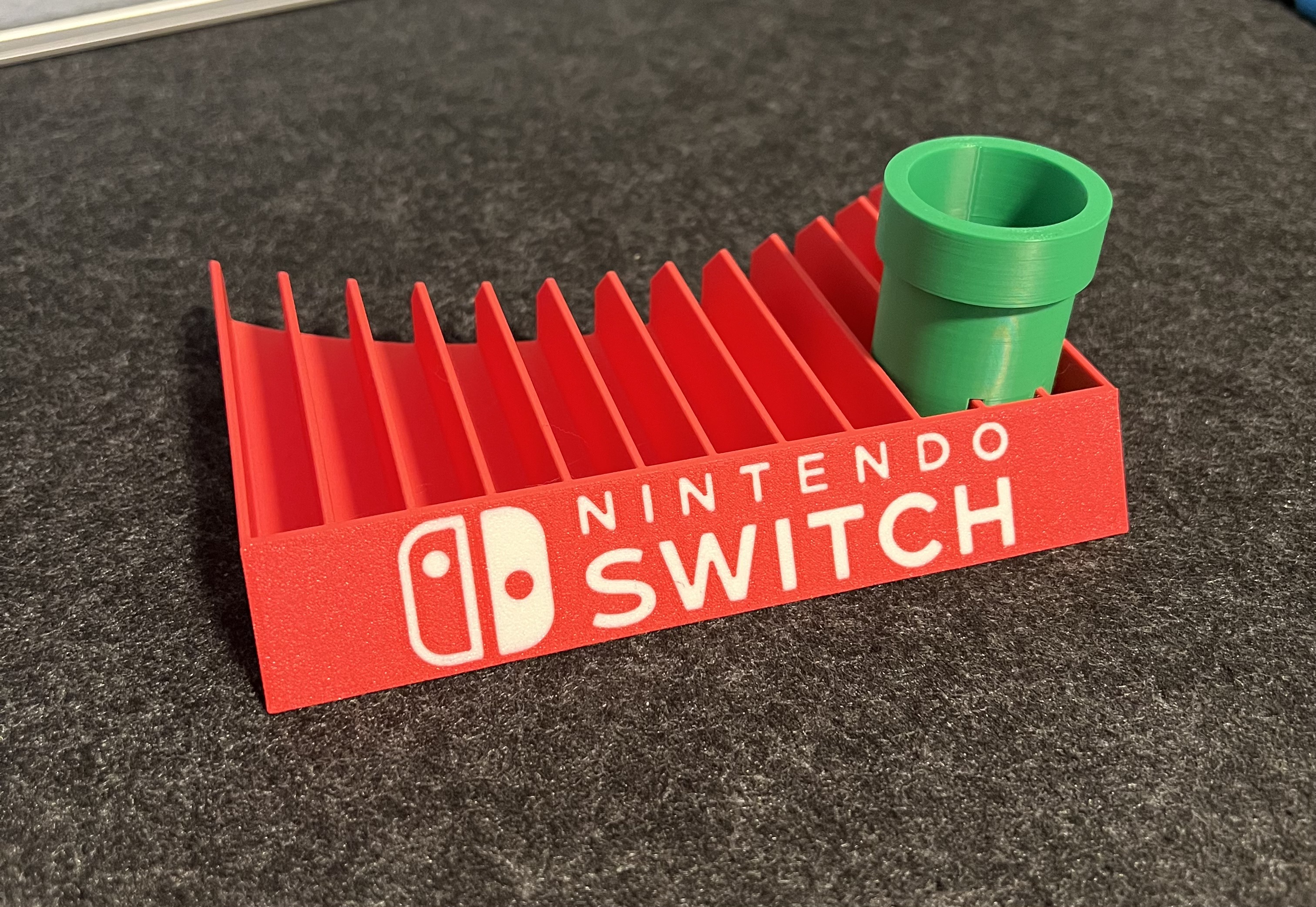 Nintendo Switch game holder with embedded logo and pipe by Sven