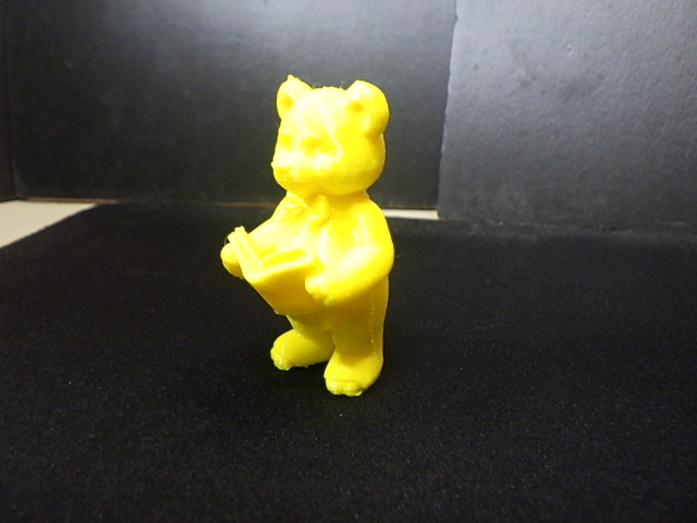 A cute teddy bear(Fitzgerald) standing, reading a book.