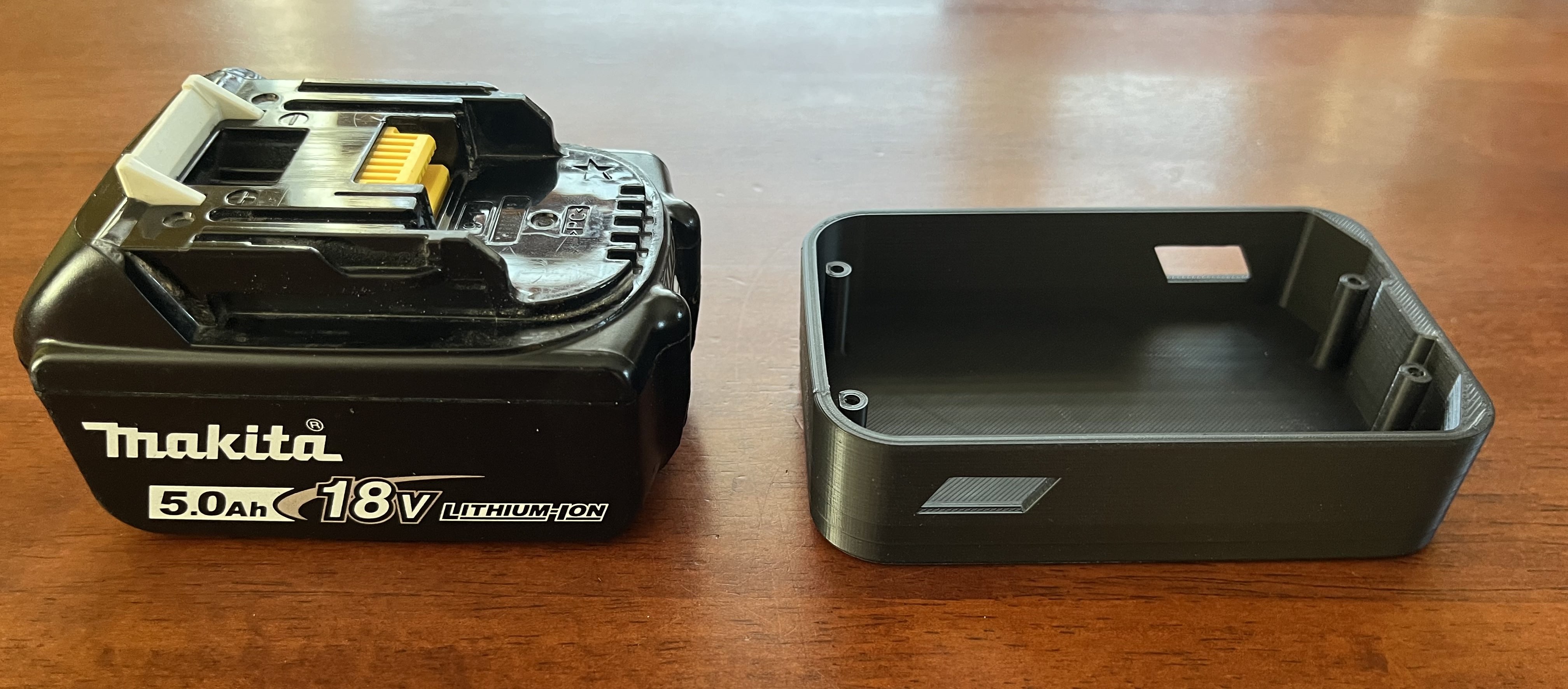 Makita 18V battery cover with magnets to hold batteri+tools on metal surfaces.