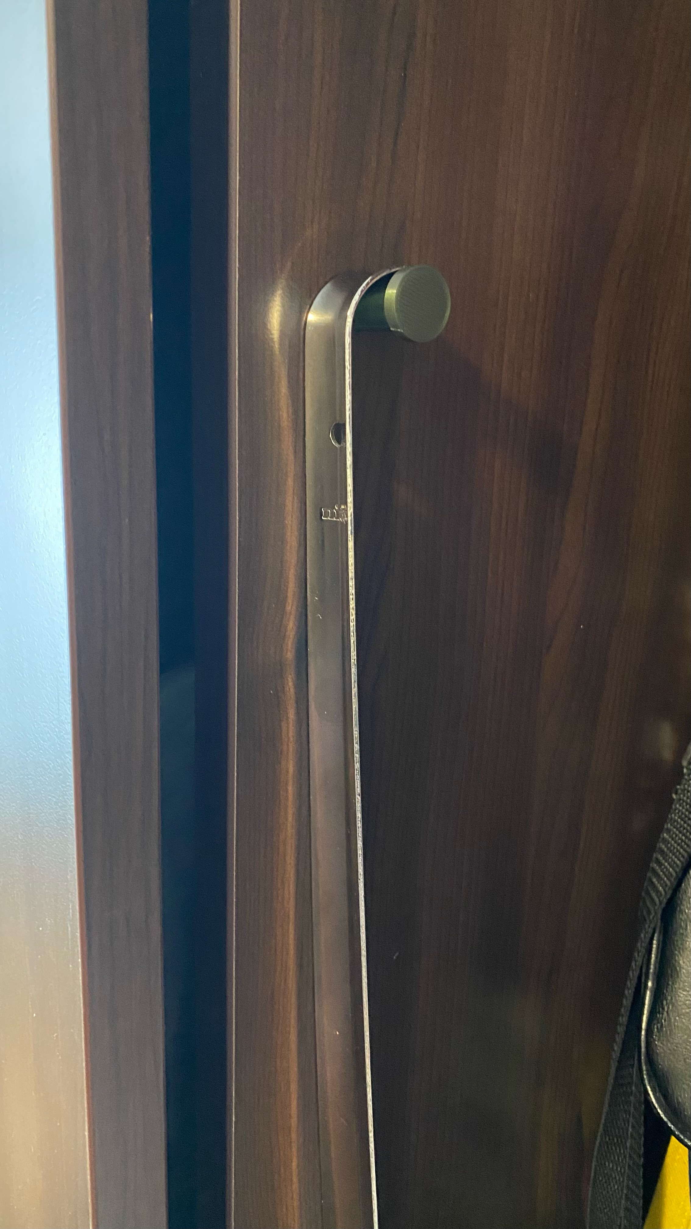 Shoehorn holder for lobby cabinet