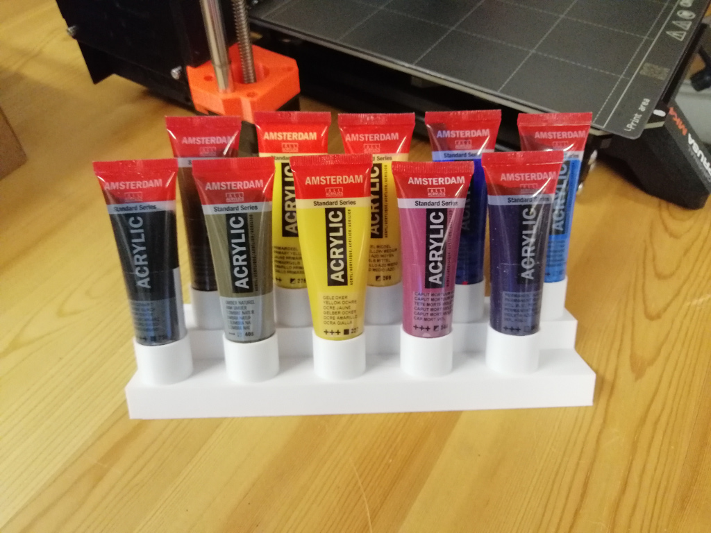 Paint tube holder and a small spoon for mixing paints