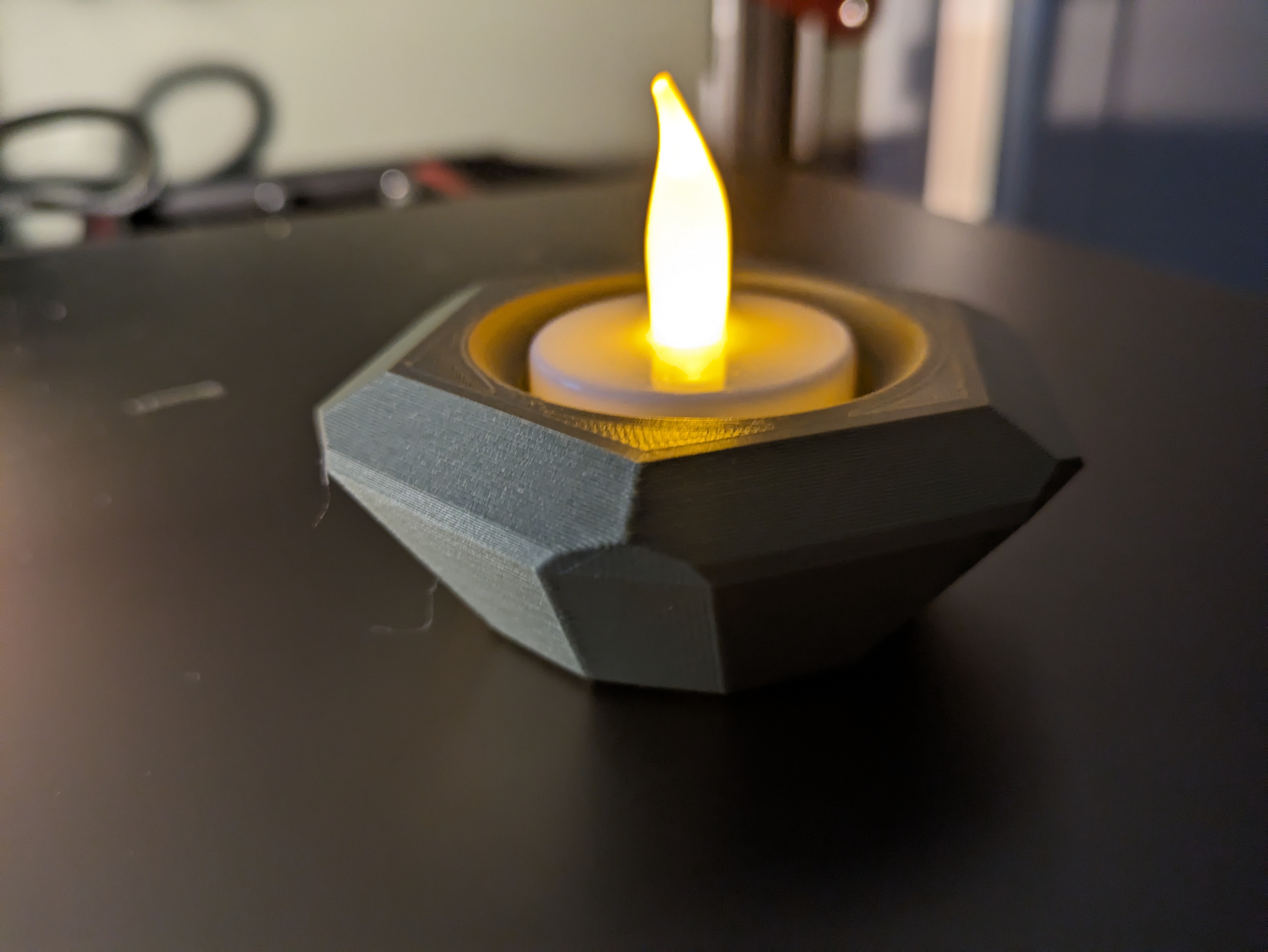 Faceted tea-candle holder.