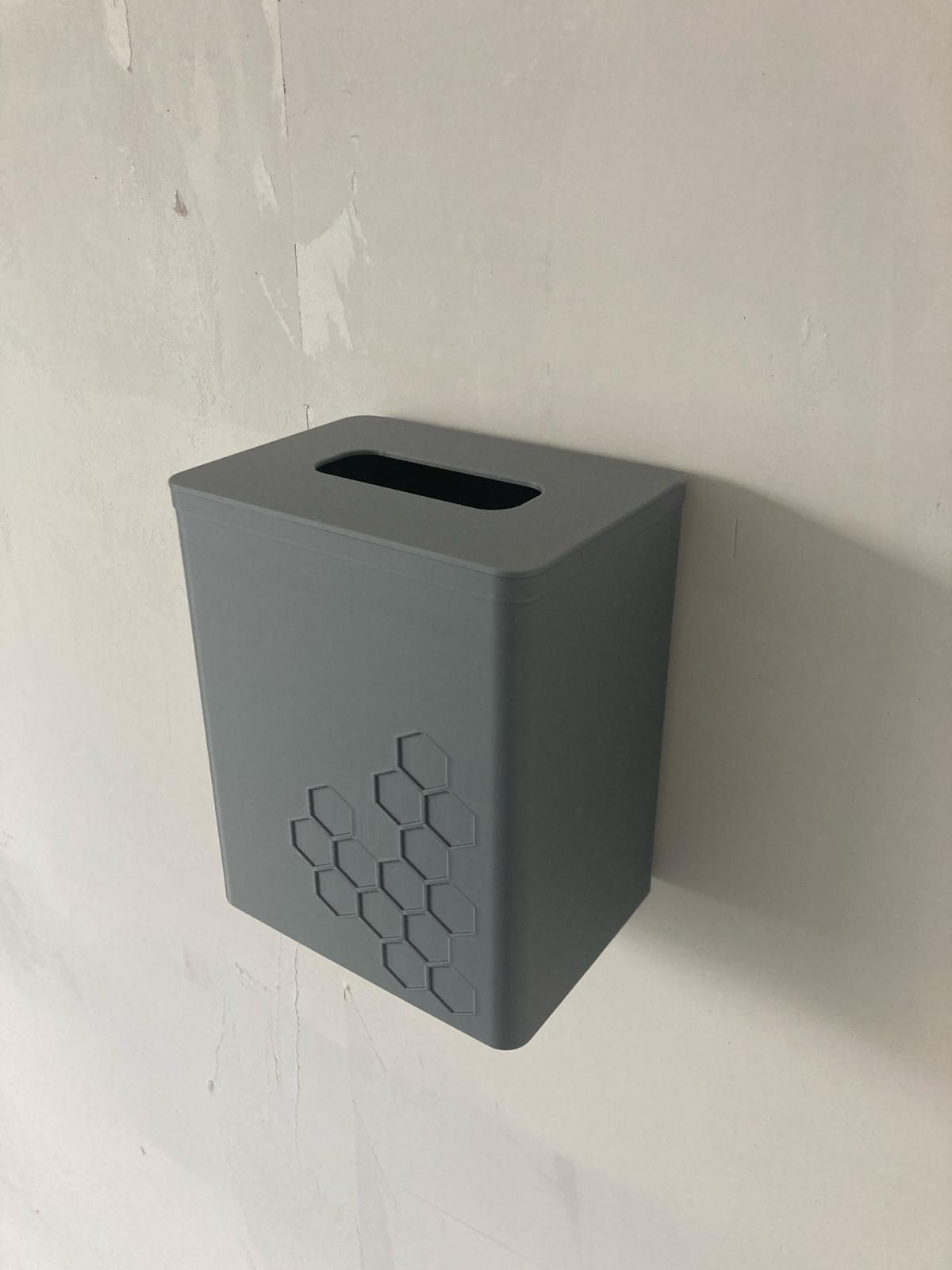 Hangable trash can for filament scraps or other waste with lid. Easy to remove from the wall with hanging system.