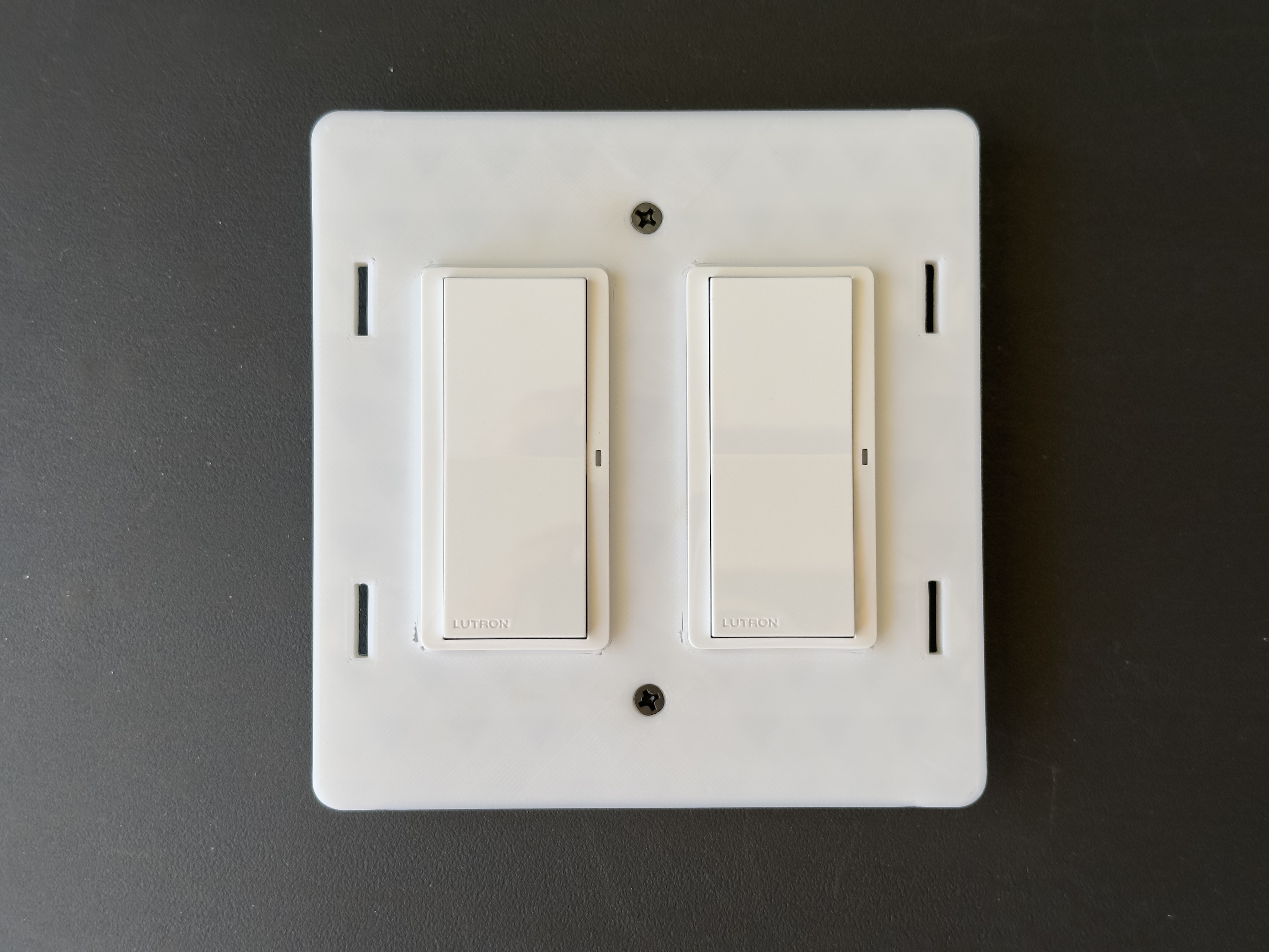 Thin Lutron Caseta Pico Remote holder for use with Wyza's screwless switch cover