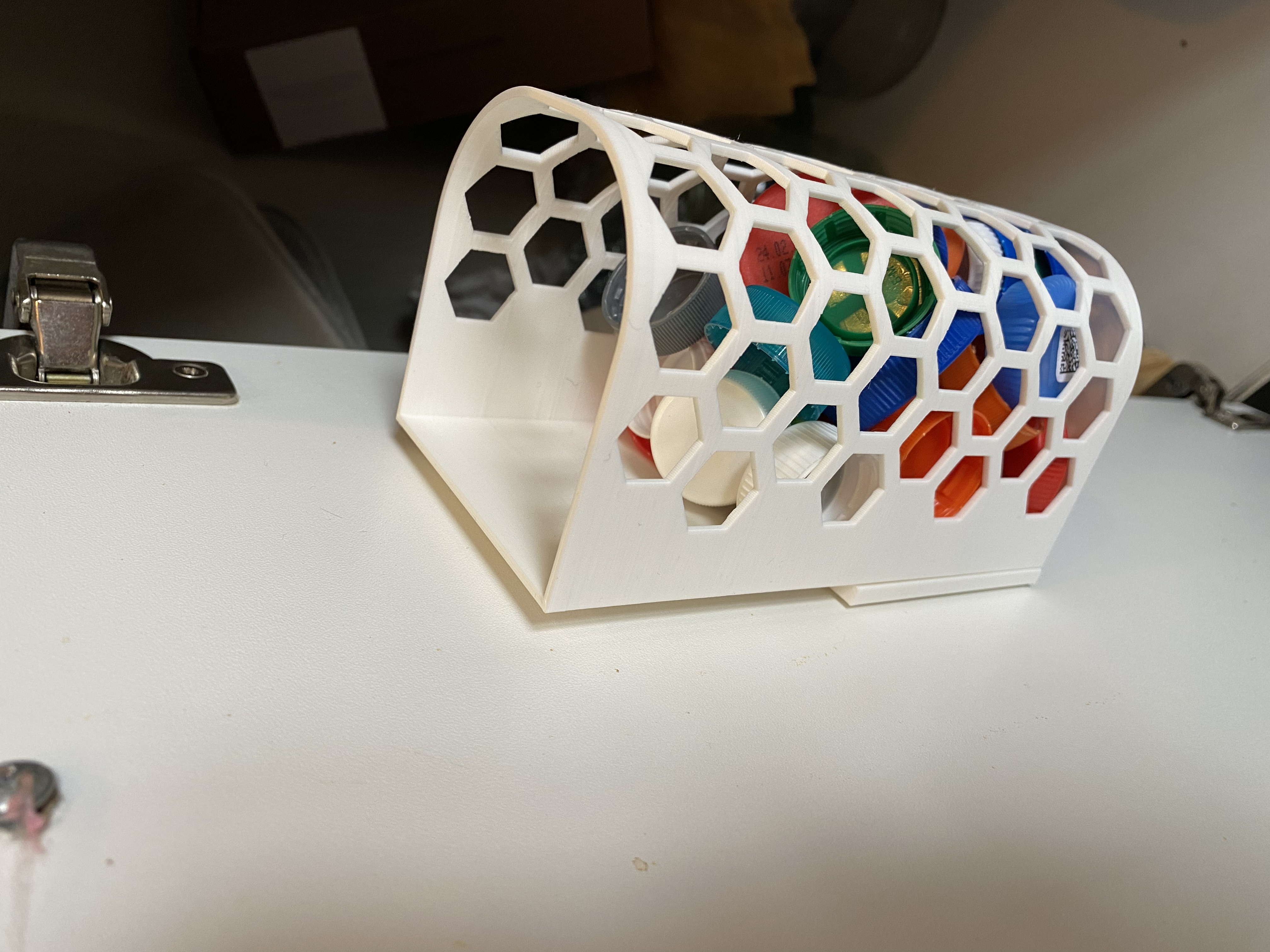 Wall mounted container for bottle caps