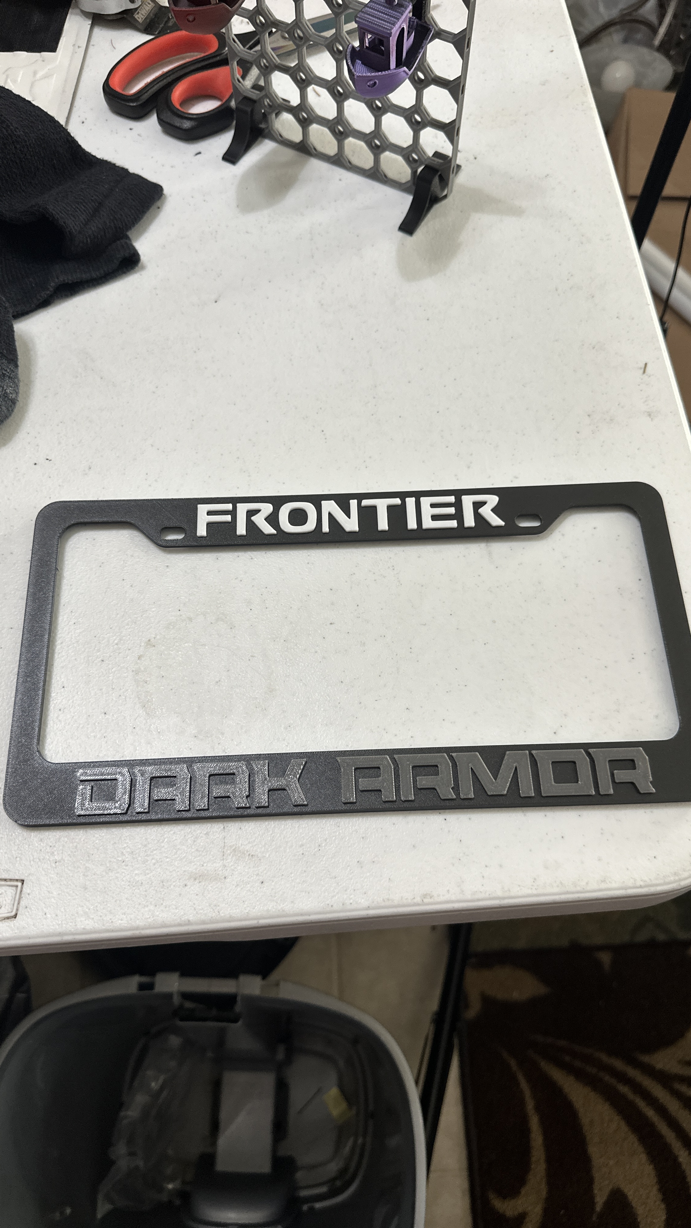 Nissan Frontier Dark Armor License Plate Cover