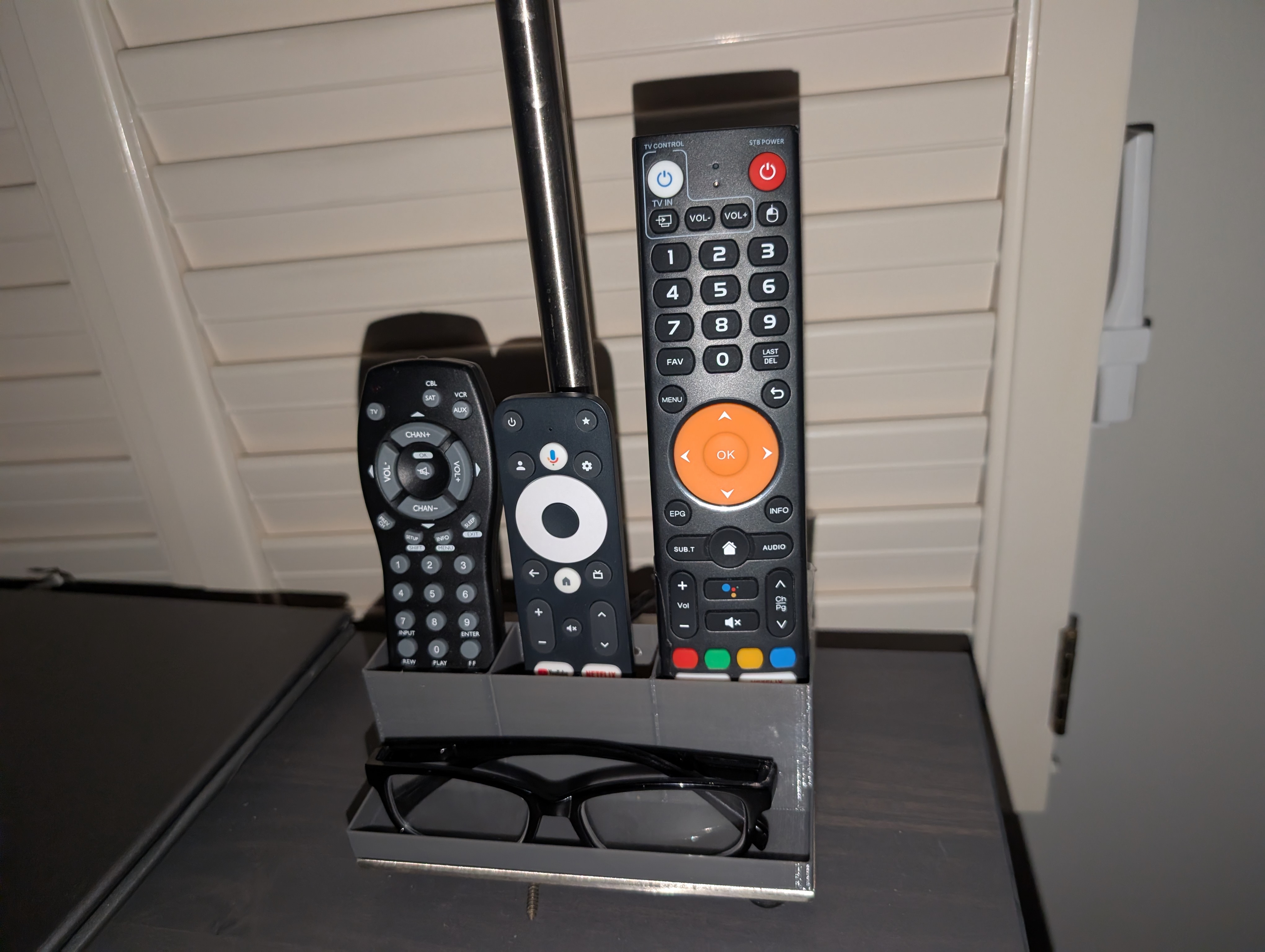 remote and glasses holder that sticks on night stand light from IKEA