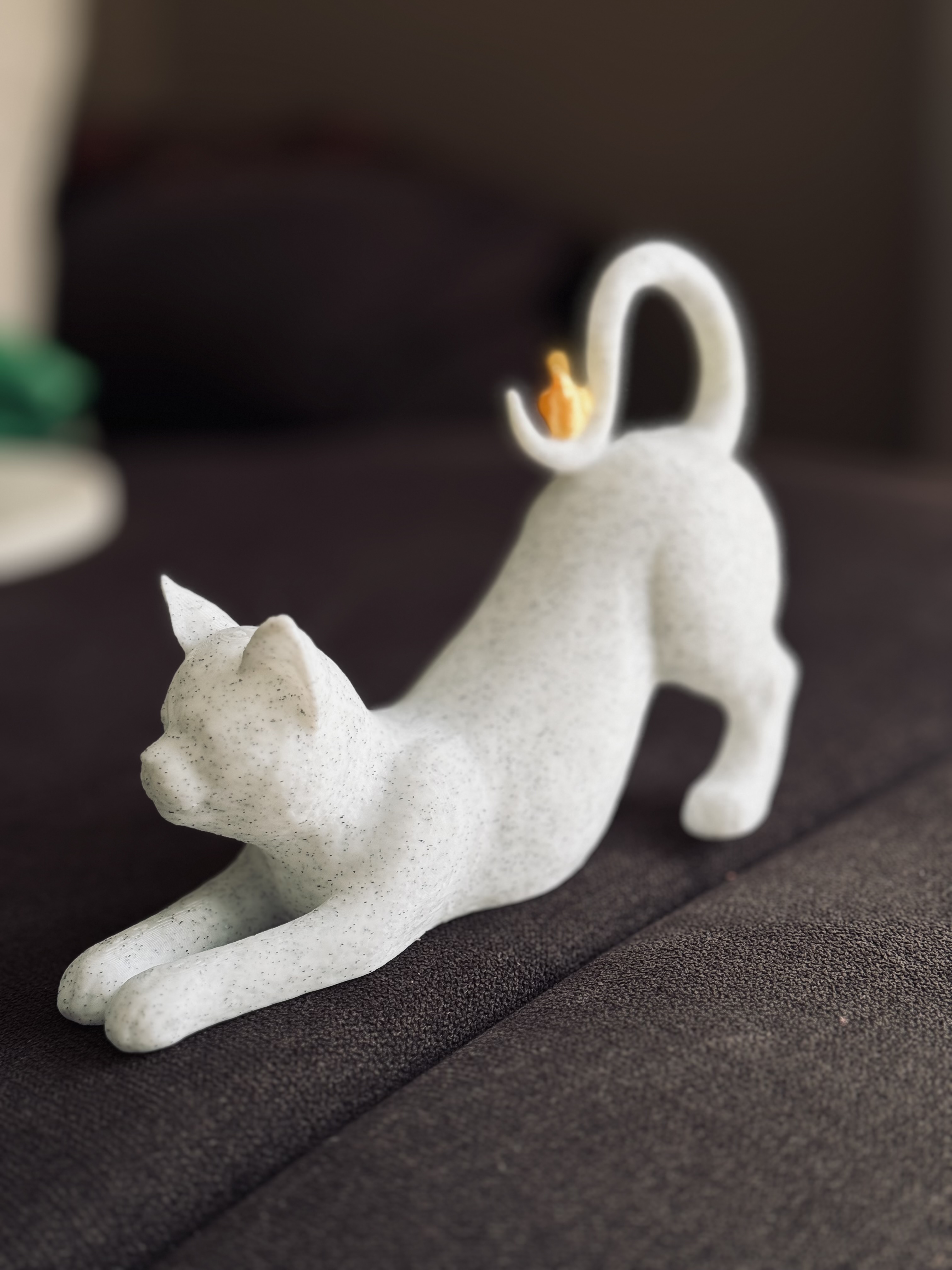 Stretching Cat with Bird on Tail